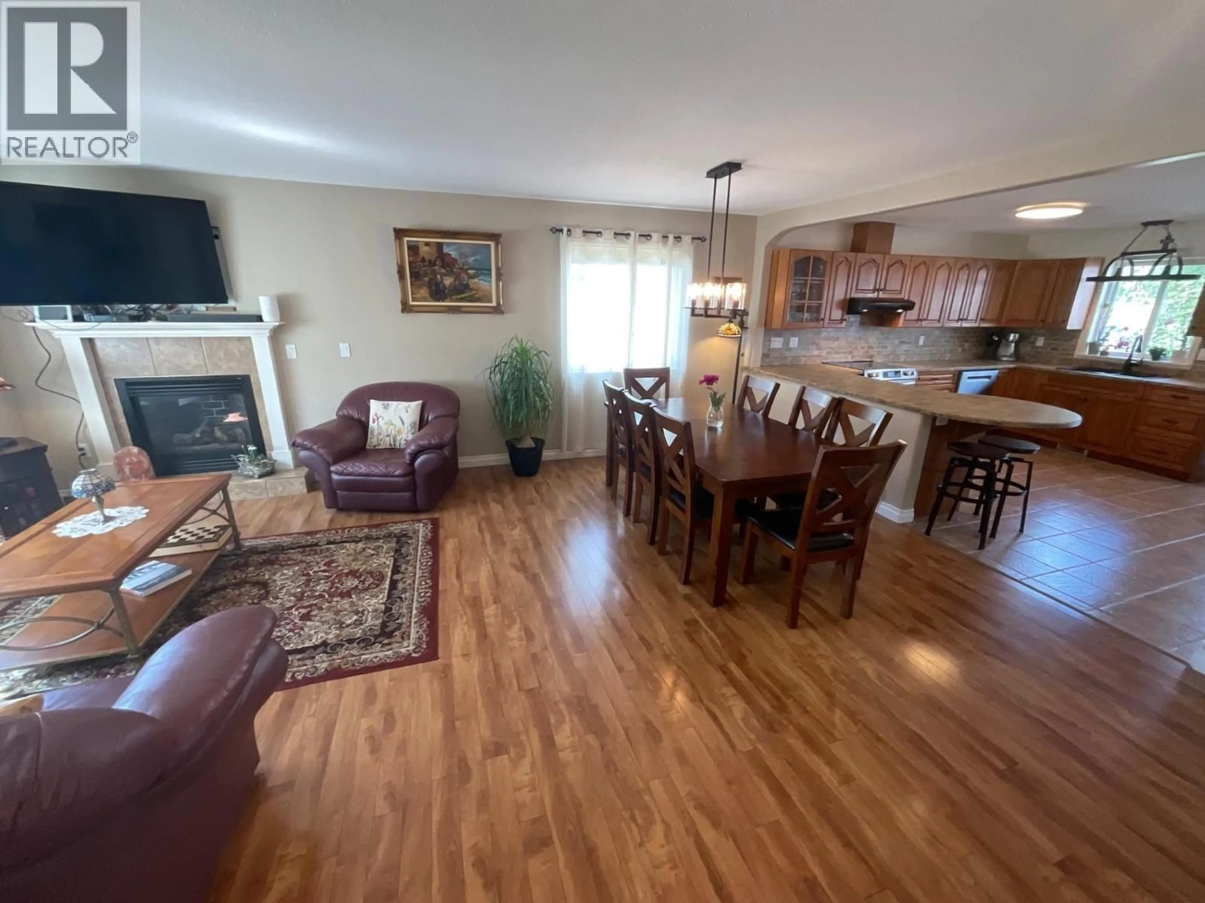 Living room with furniture, wood/laminate floor for 11411 98 STREET, Fort St. John British Columbia V1J7B5
