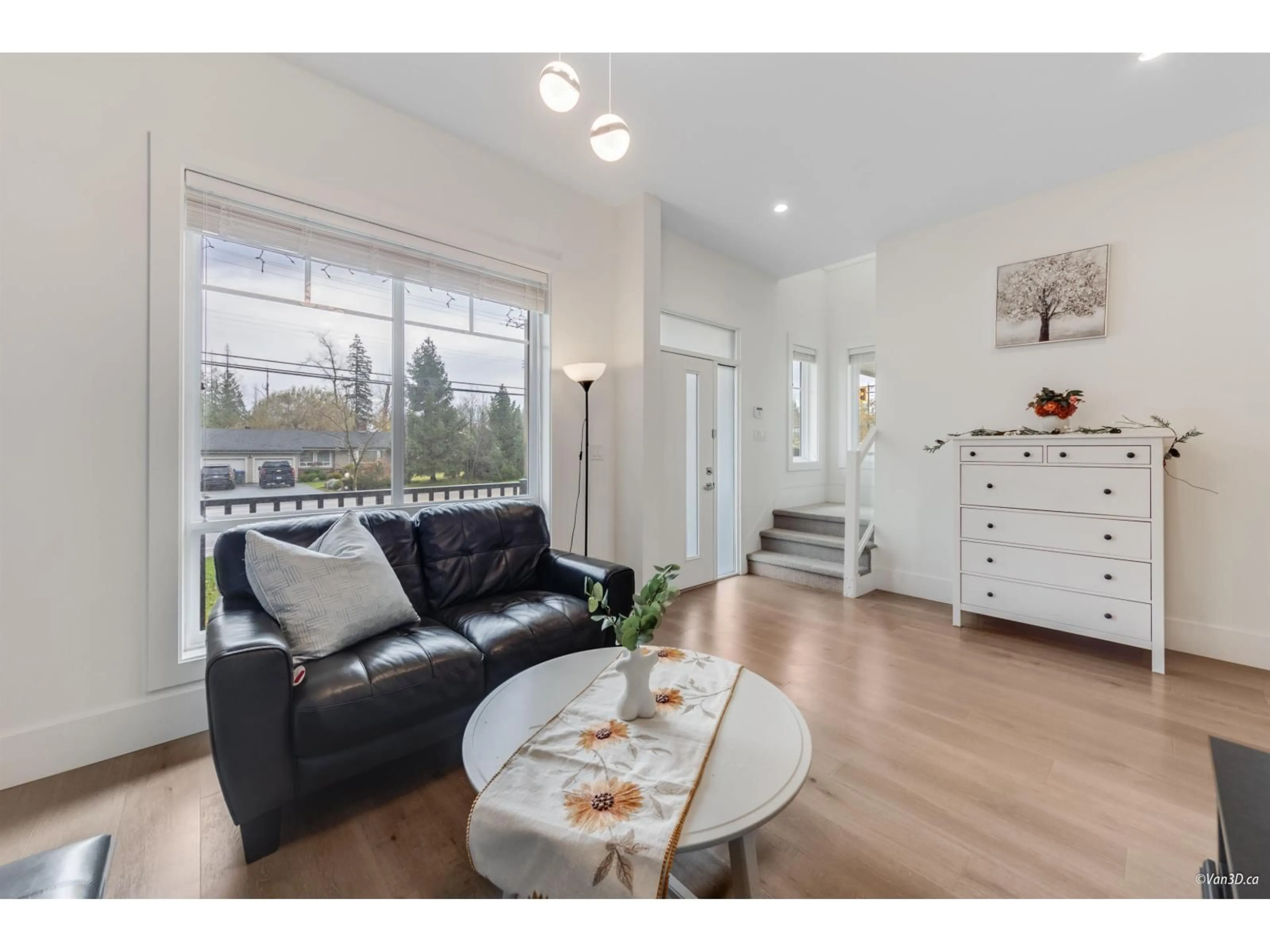 Living room with furniture, wood/laminate floor for 2517 168 STREET, Surrey British Columbia V3Z0A7