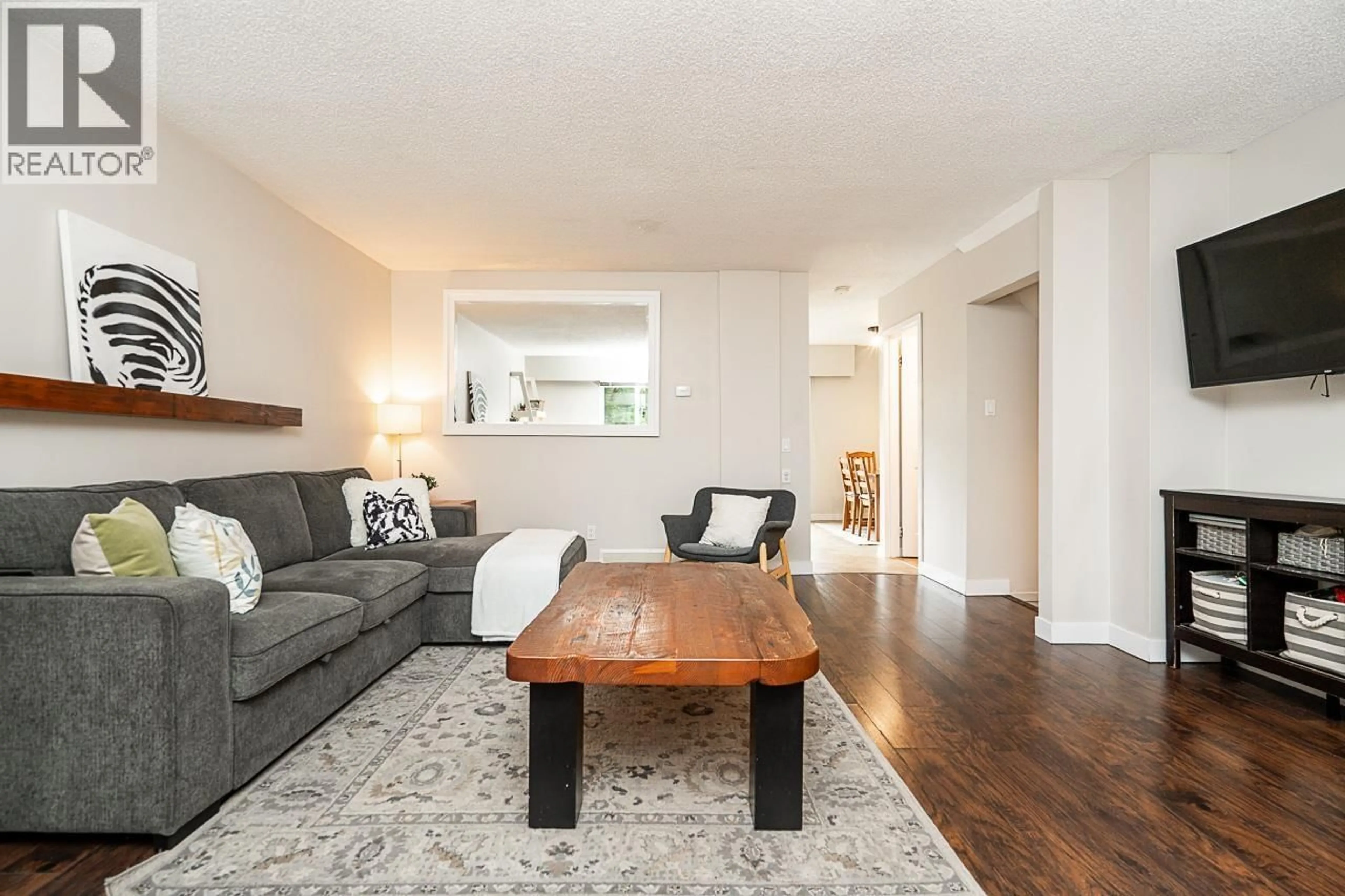 Living room with furniture, wood/laminate floor for 130 - 9061 HORNE STREET, Burnaby British Columbia V3N4L2