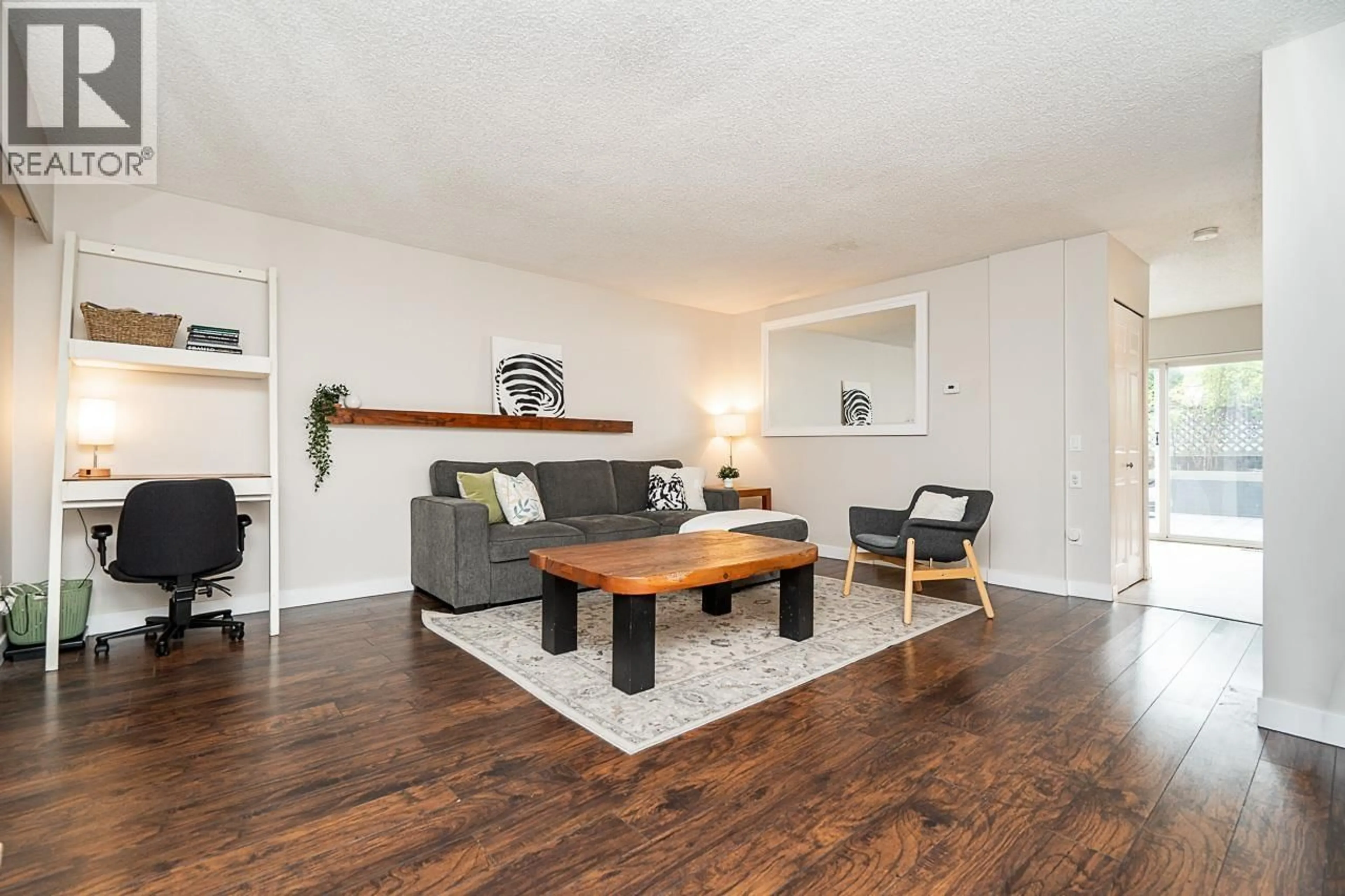 Living room with furniture, wood/laminate floor for 130 - 9061 HORNE STREET, Burnaby British Columbia V3N4L2