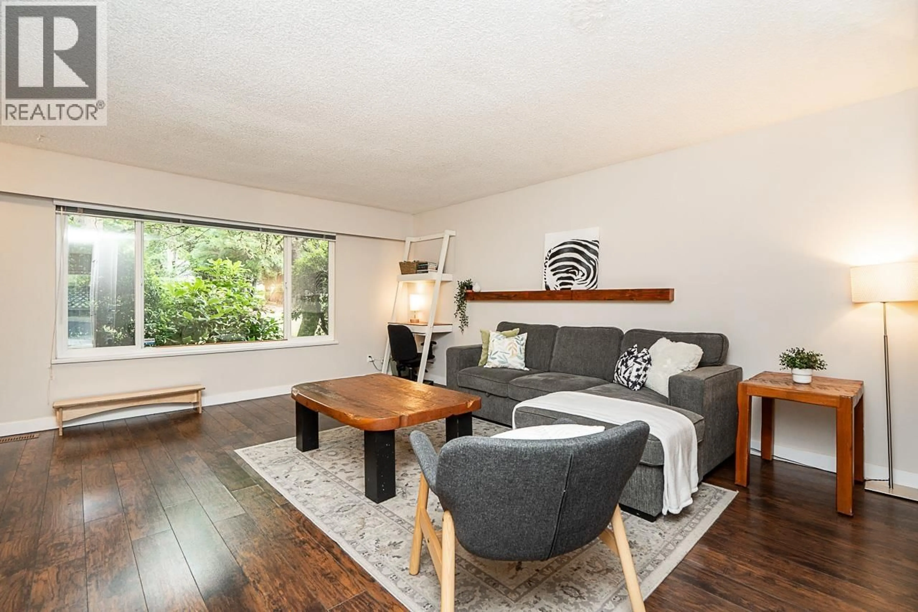 Living room with furniture, wood/laminate floor for 130 - 9061 HORNE STREET, Burnaby British Columbia V3N4L2