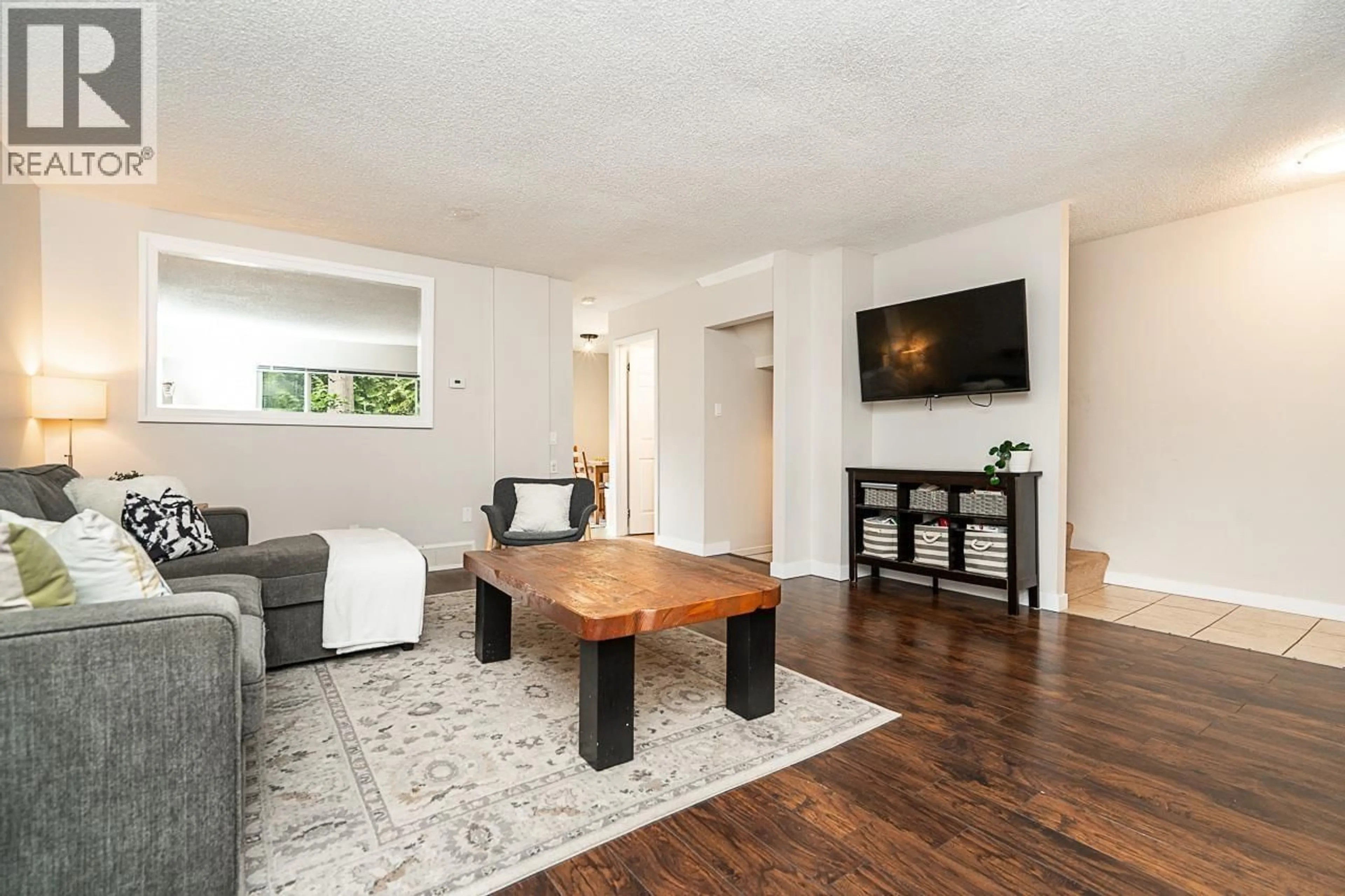 Living room with furniture, wood/laminate floor for 130 - 9061 HORNE STREET, Burnaby British Columbia V3N4L2