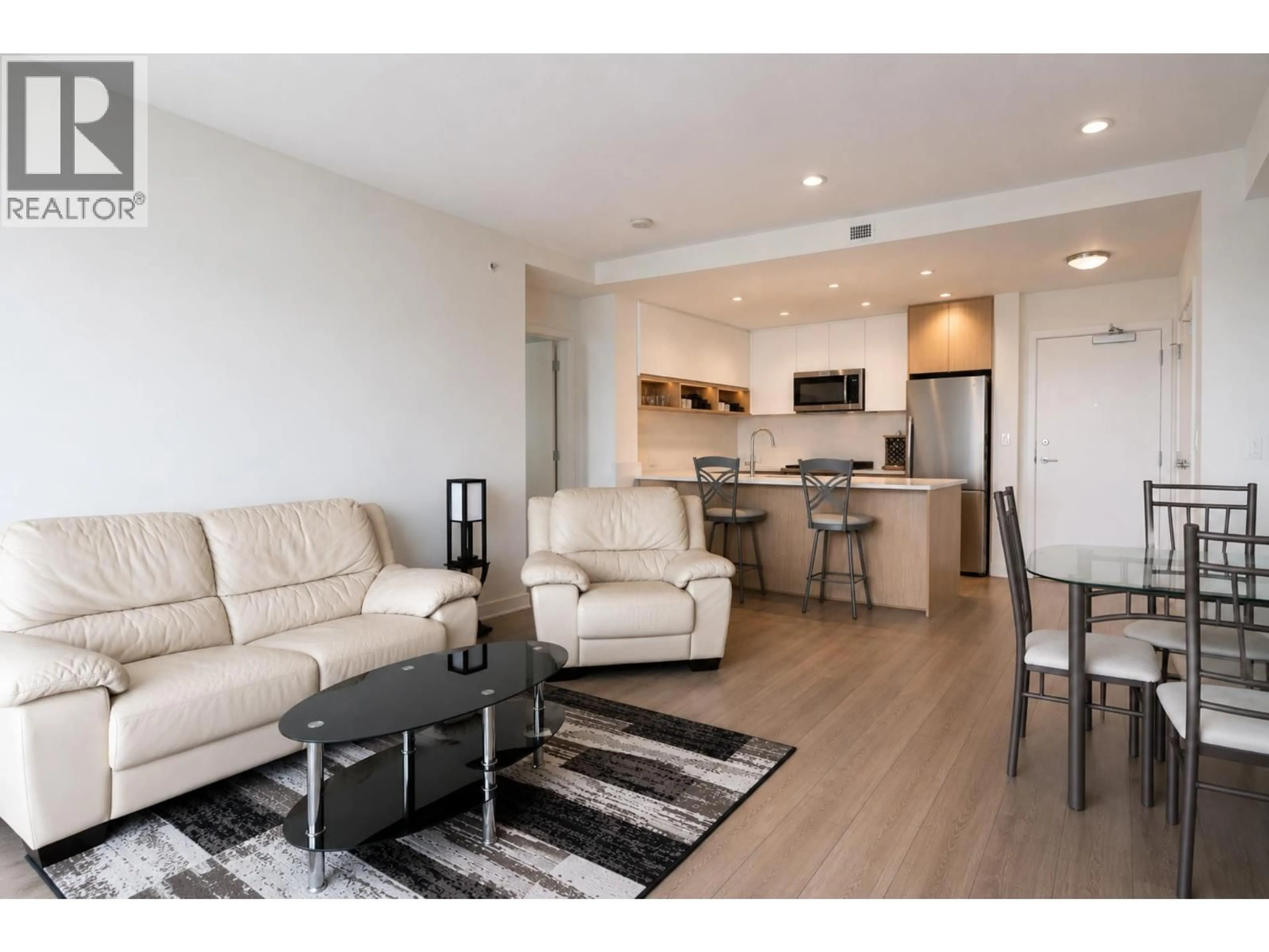 Living room with furniture, wood/laminate floor for 308 - 8940 UNIVERSITY CRESCENT, Burnaby British Columbia V5A0E7