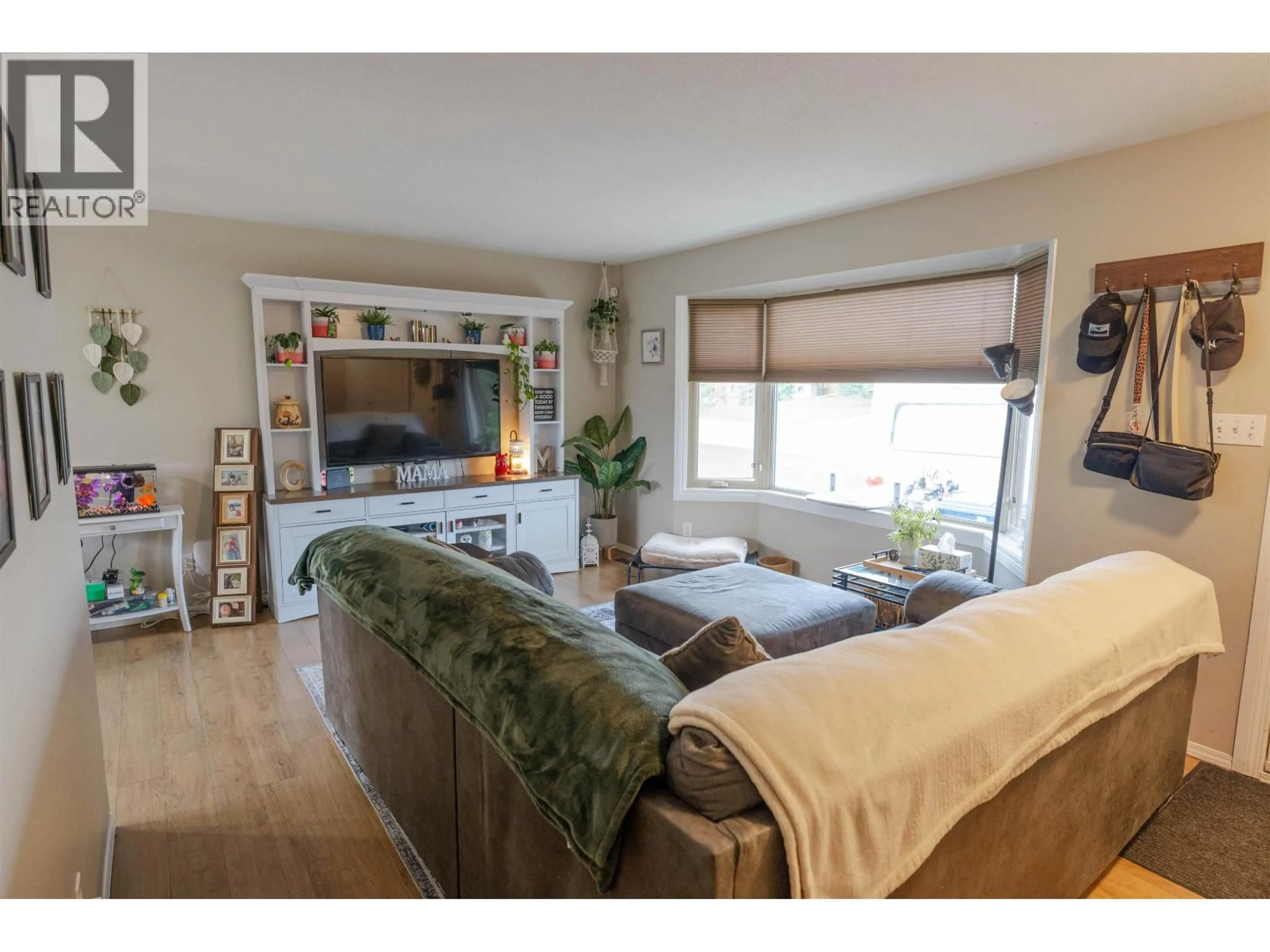 Living room with furniture, wood/laminate floor for 8507 94 AVENUE, Fort St. John British Columbia V1J1E9