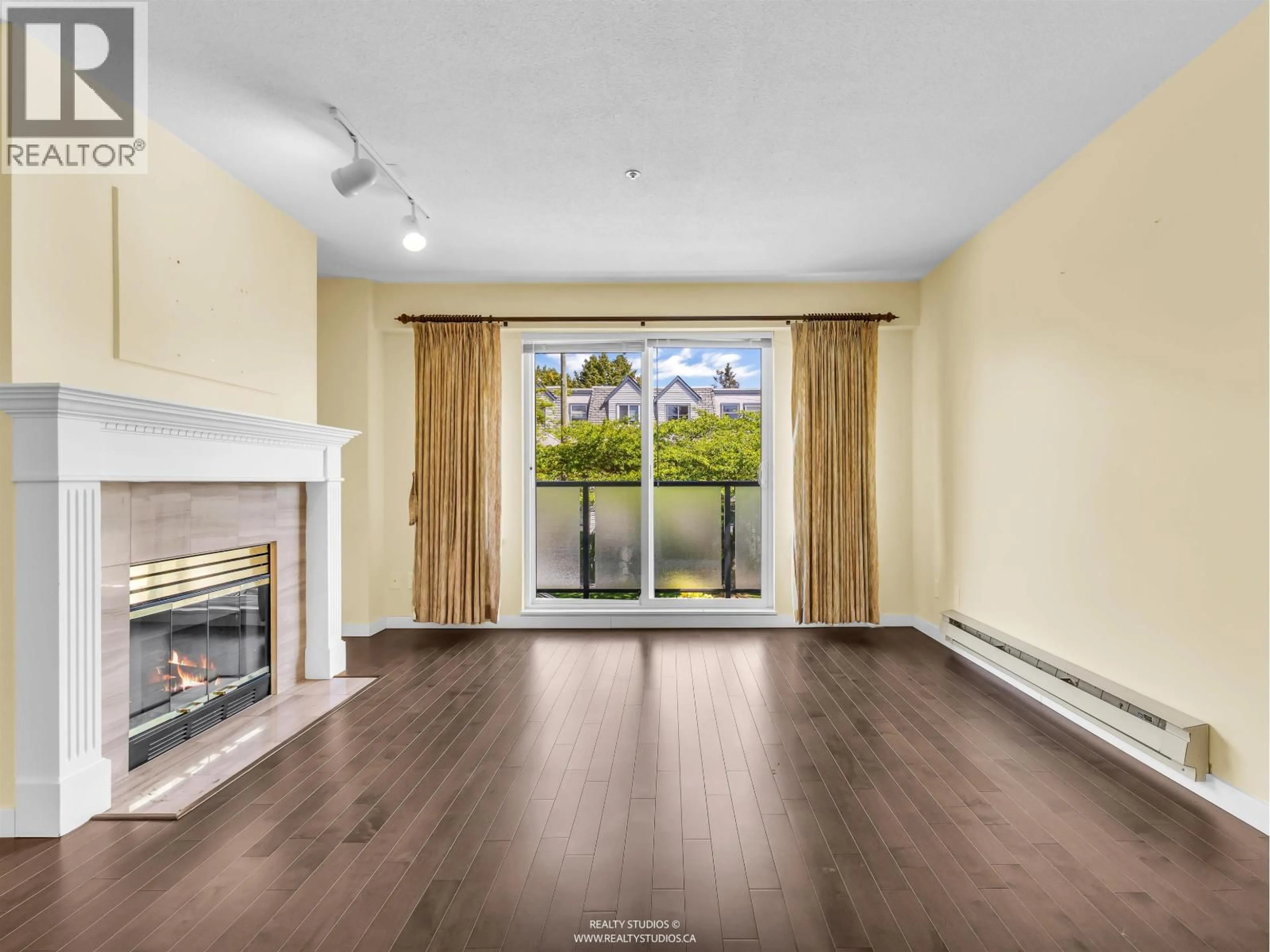Living room with furniture, wood/laminate floor for 204 - 876 16TH AVENUE, Vancouver British Columbia V5Z1T1