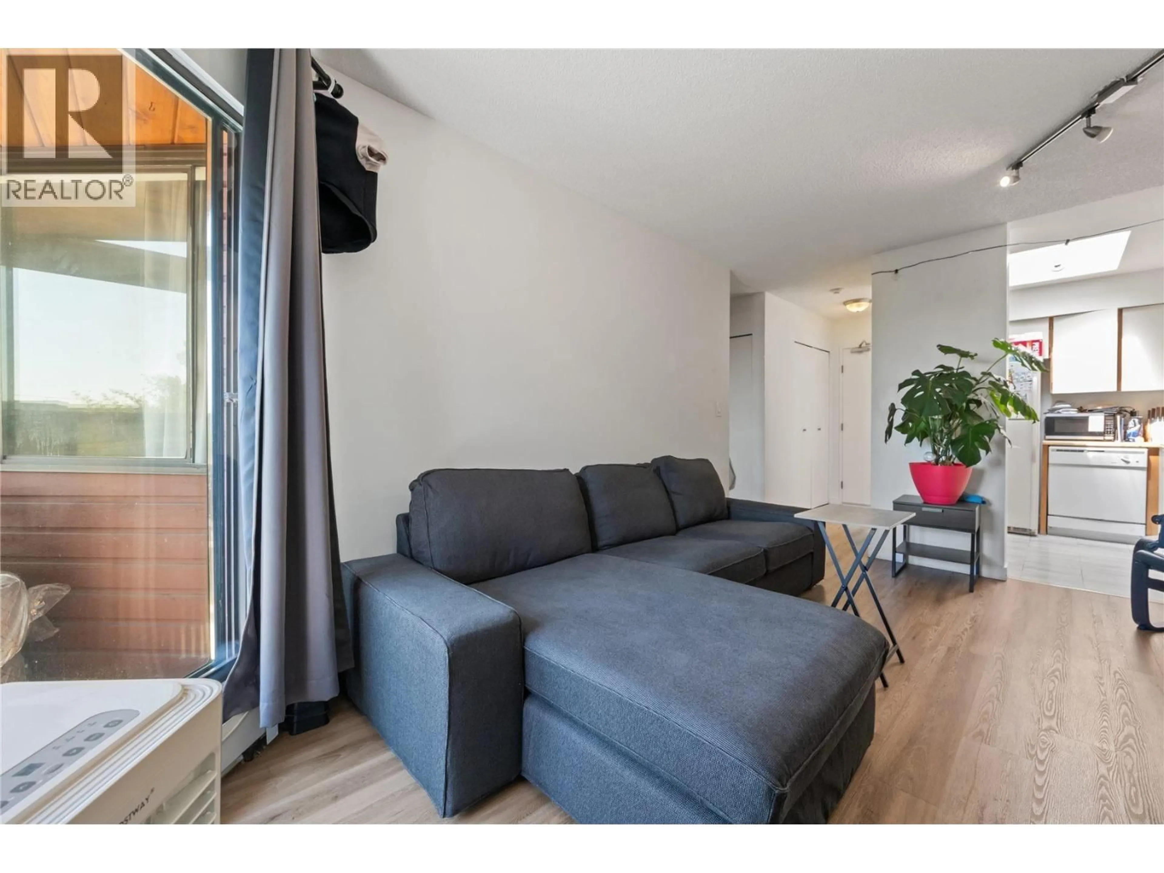 Living room with furniture, wood/laminate floor for 313 - 1177 HOWIE AVENUE AVENUE, Coquitlam British Columbia V3J1T9