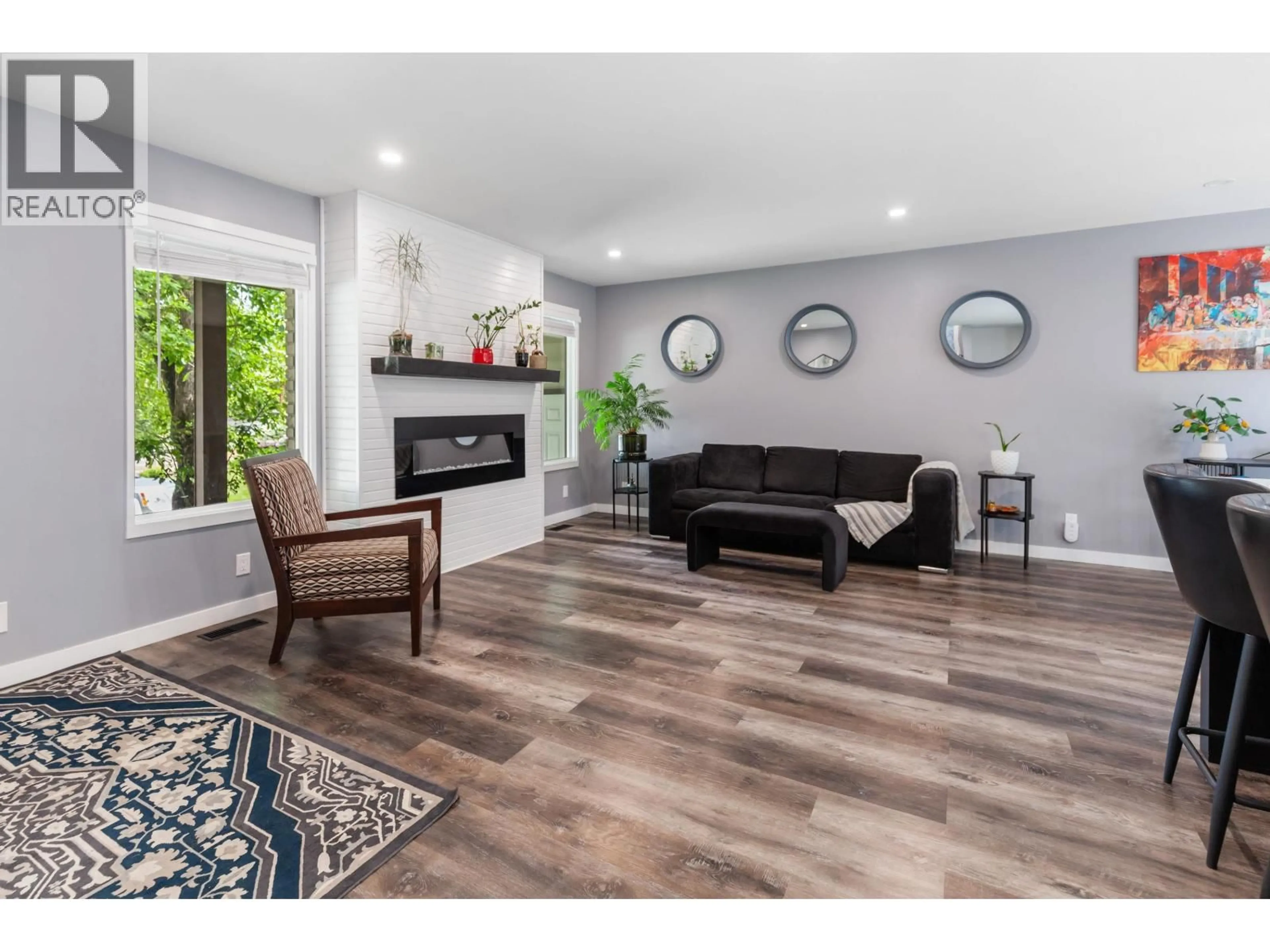 Living room with furniture, wood/laminate floor for 7197 GUELPH CRESCENT, Prince George British Columbia V2N4A2