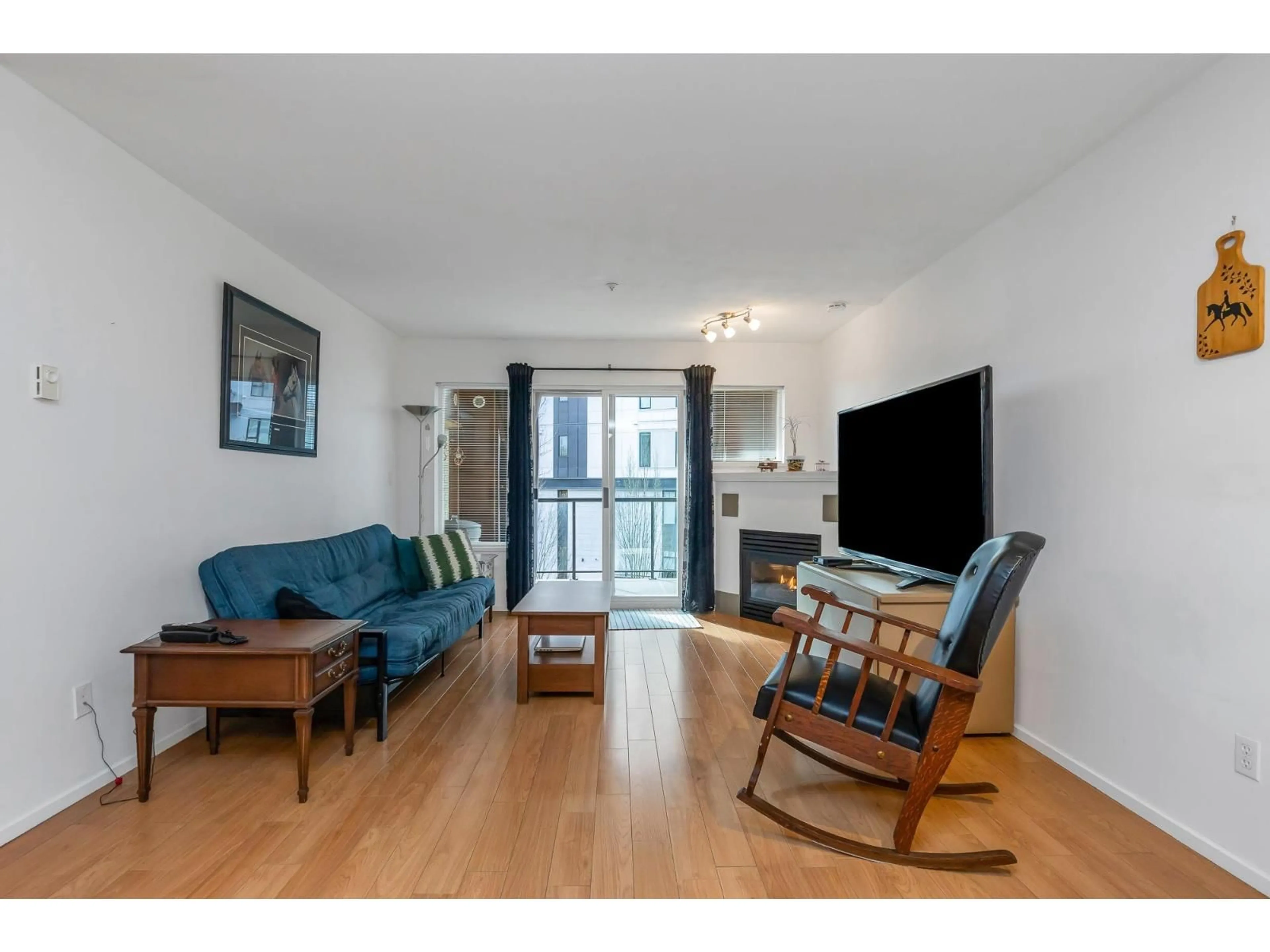 Living room with furniture, wood/laminate floor for 308 - 20239 MICHAUD CRESCENT, Langley British Columbia V3A8L1