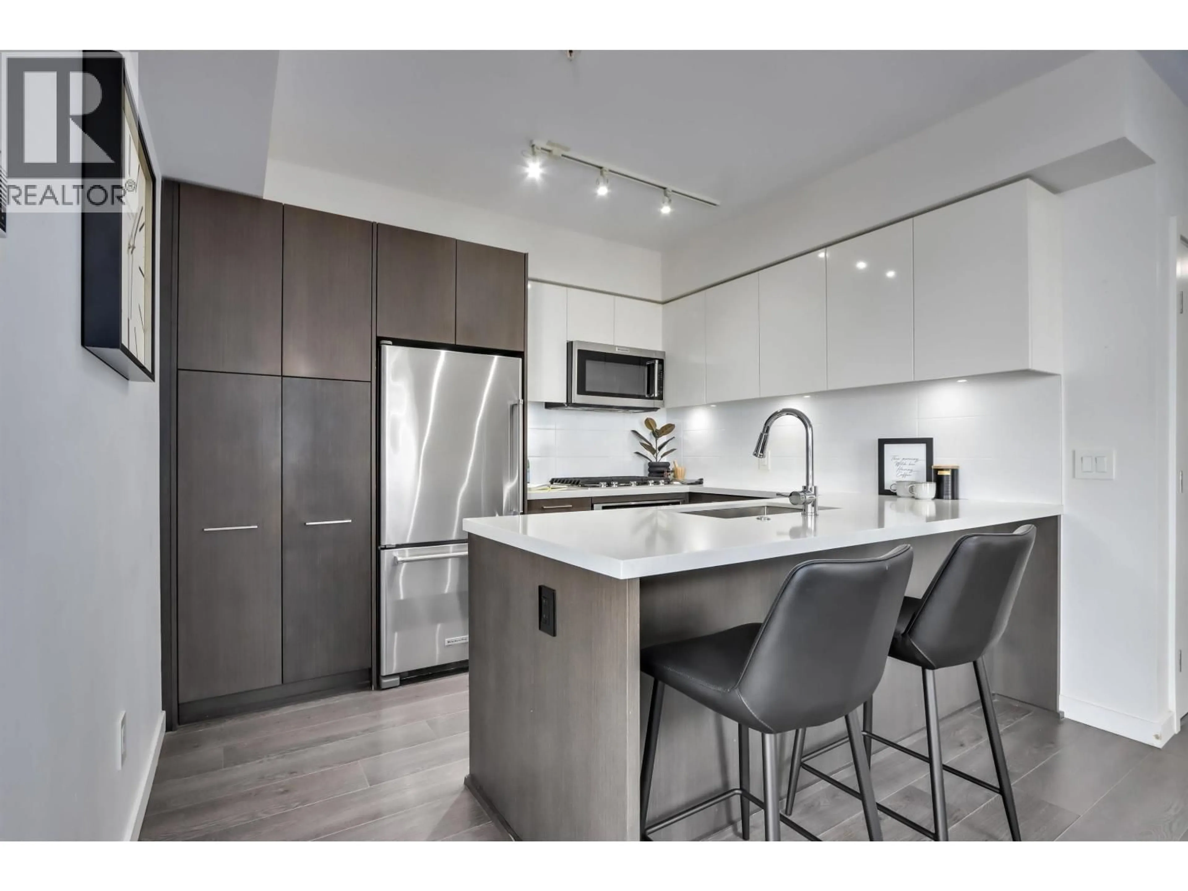 Open concept kitchen, wood/laminate floor for 313 - 417 GREAT NORTHERN WAY, Vancouver British Columbia V5T0G7