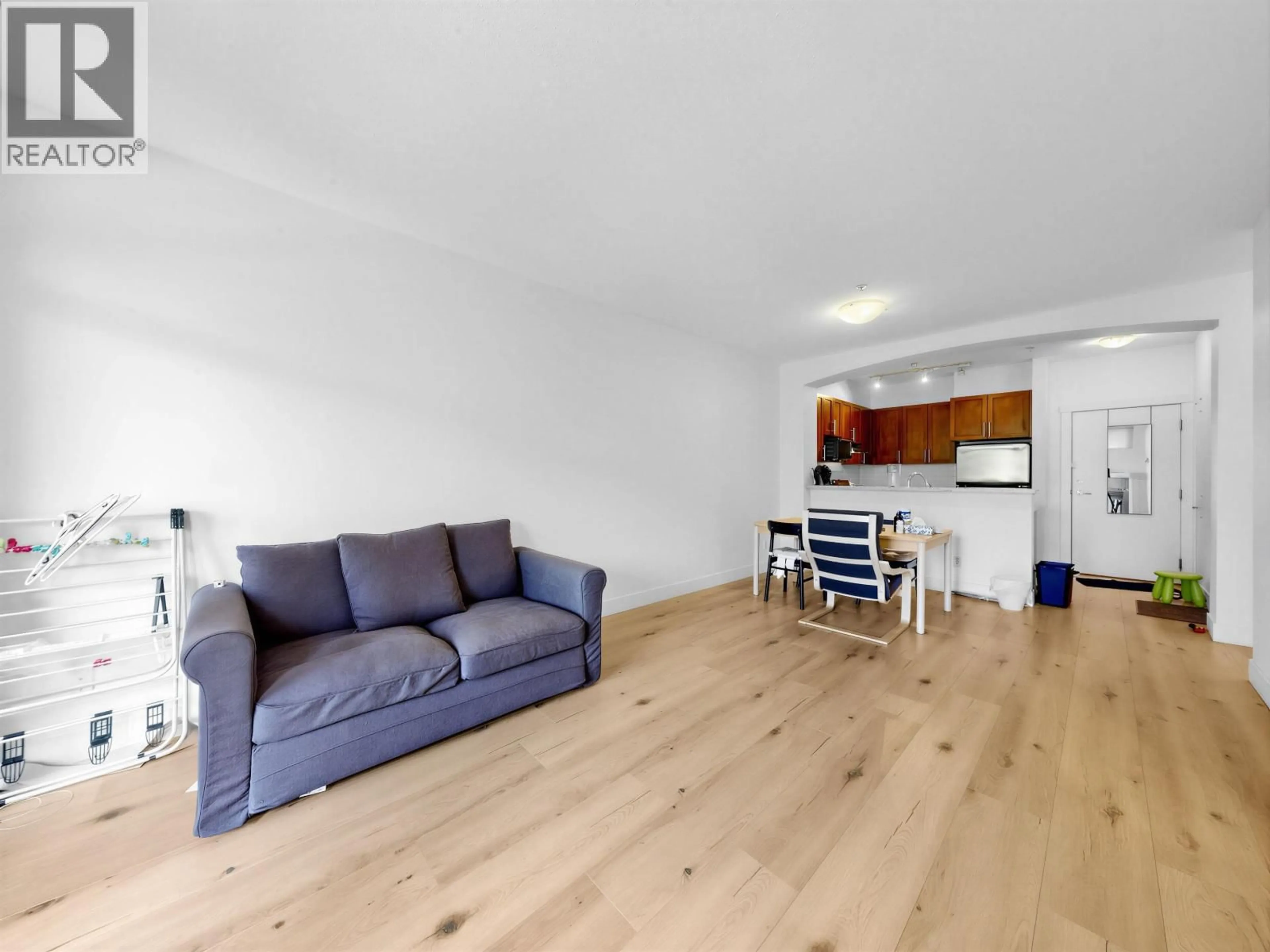 Living room with furniture, wood/laminate floor for 319 - 2250 WESBROOK MALL, Vancouver British Columbia V6T0A6