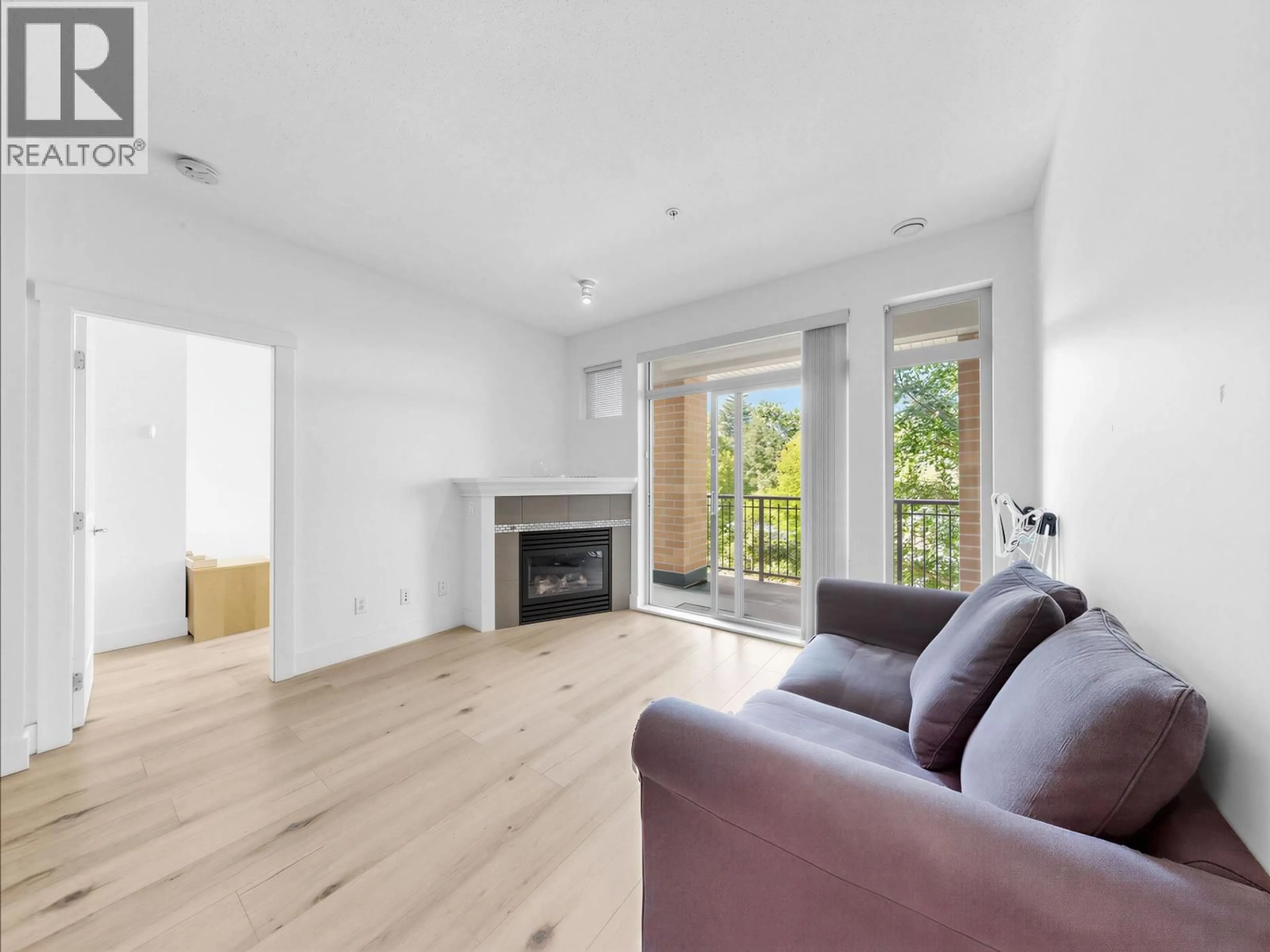 Living room with furniture, wood/laminate floor for 319 - 2250 WESBROOK MALL, Vancouver British Columbia V6T0A6