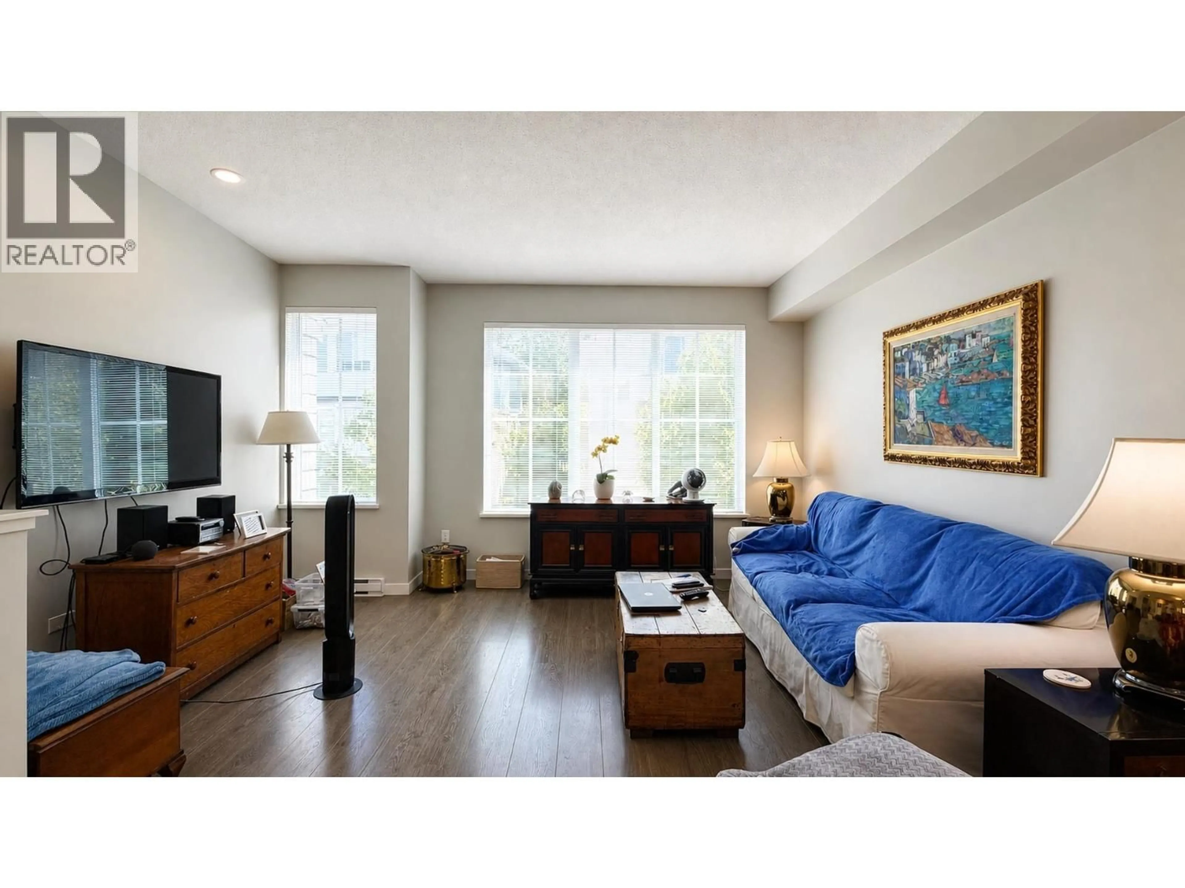 Living room with furniture, wood/laminate floor for 101 - 5550 ADMIRAL WAY, Delta British Columbia V4K0C4