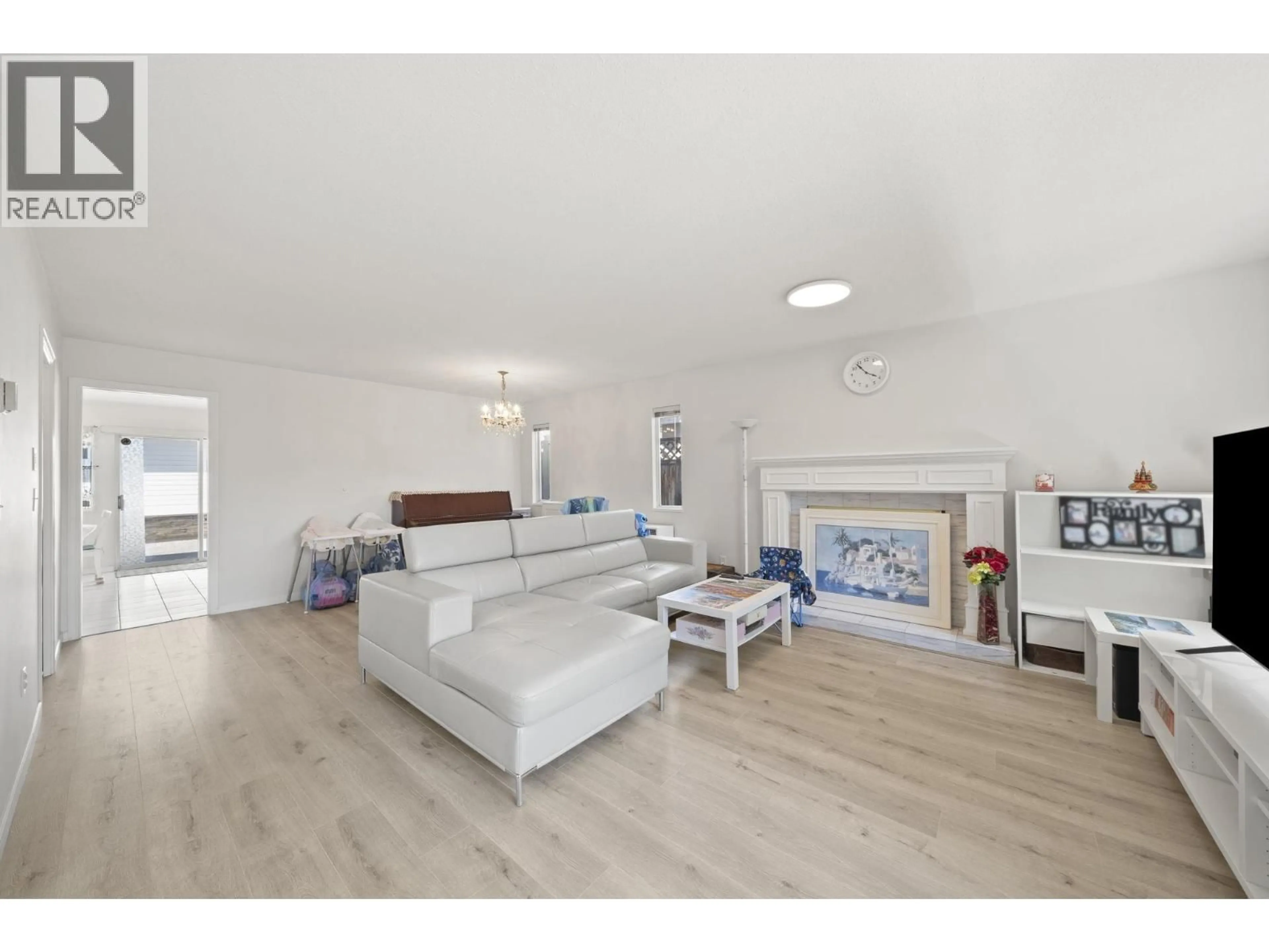 Living room with furniture, wood/laminate floor for 1855 53RD AVENUE, Vancouver British Columbia V5P1X5