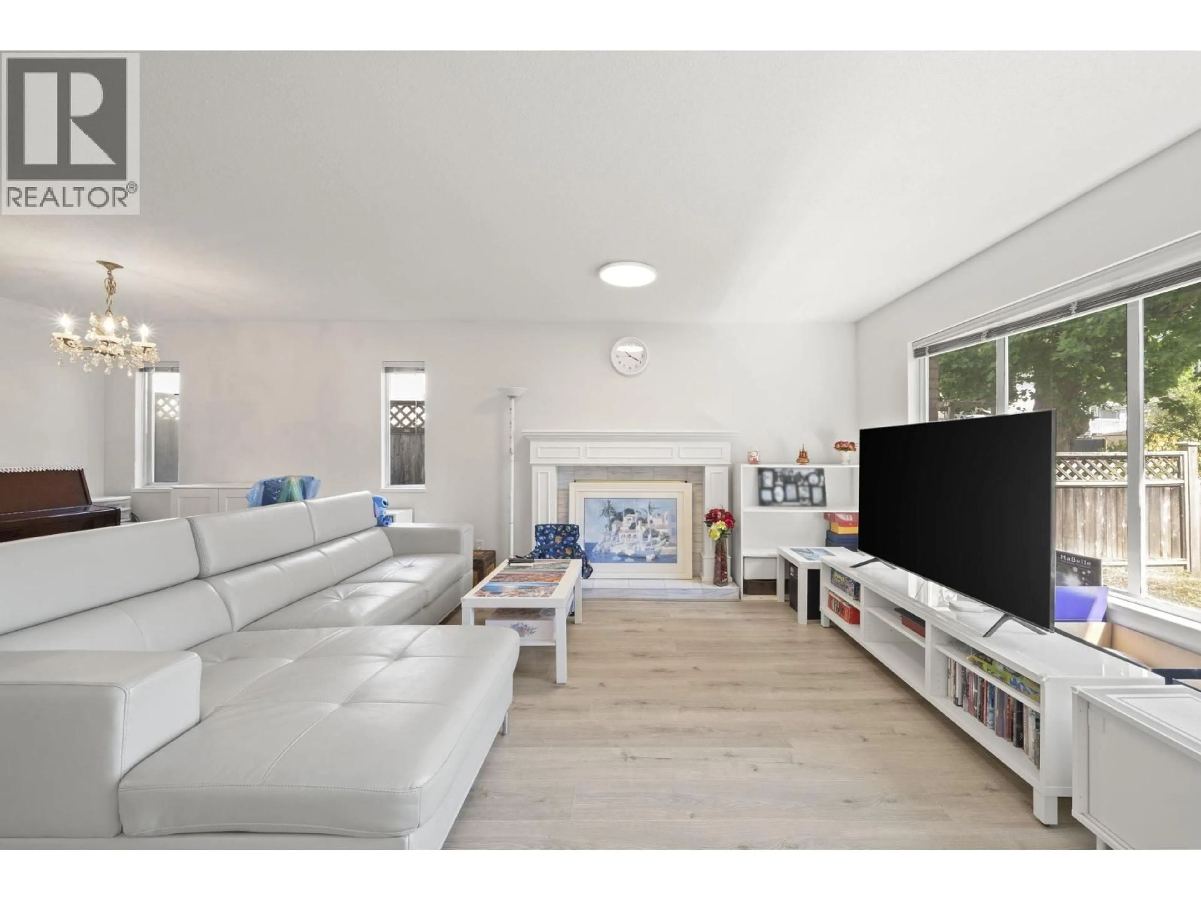 Living room with furniture, wood/laminate floor for 1855 53RD AVENUE, Vancouver British Columbia V5P1X5