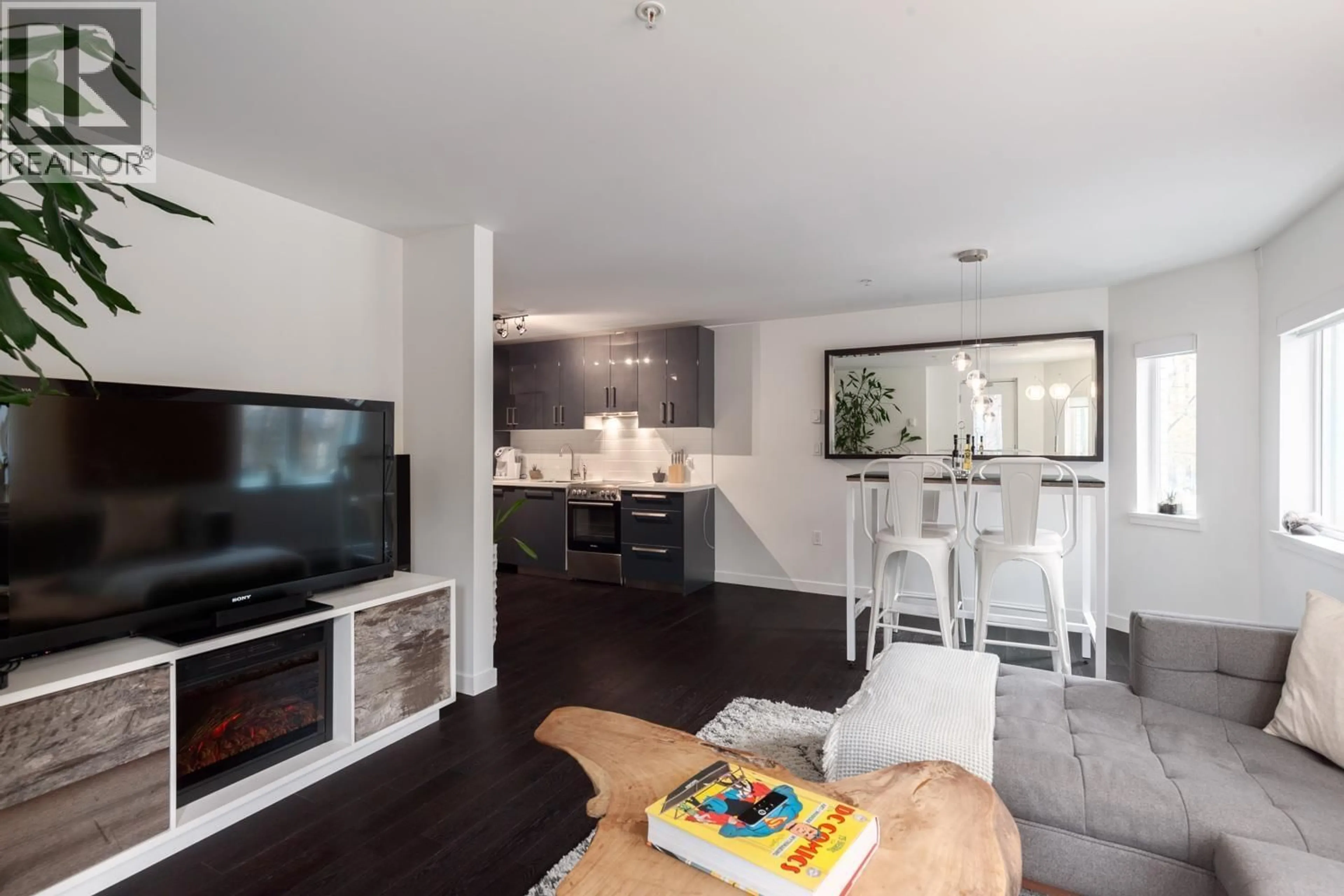 Living room with furniture, wood/laminate floor for 203 - 370 CARRALL STREET, Vancouver British Columbia V6B2J3