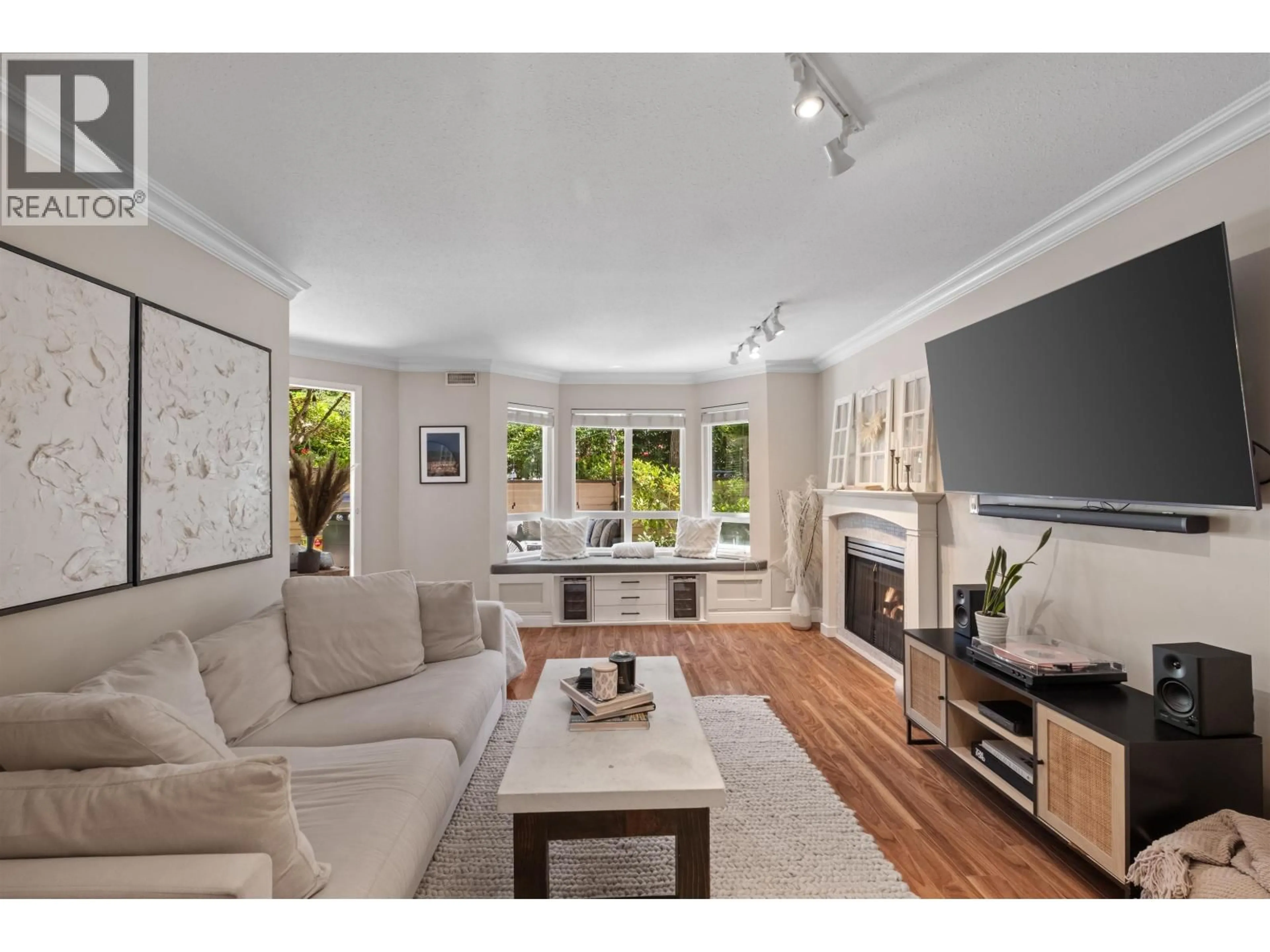 Living room with furniture, wood/laminate floor for 102 - 123 6TH STREET, North Vancouver British Columbia V7L1N9