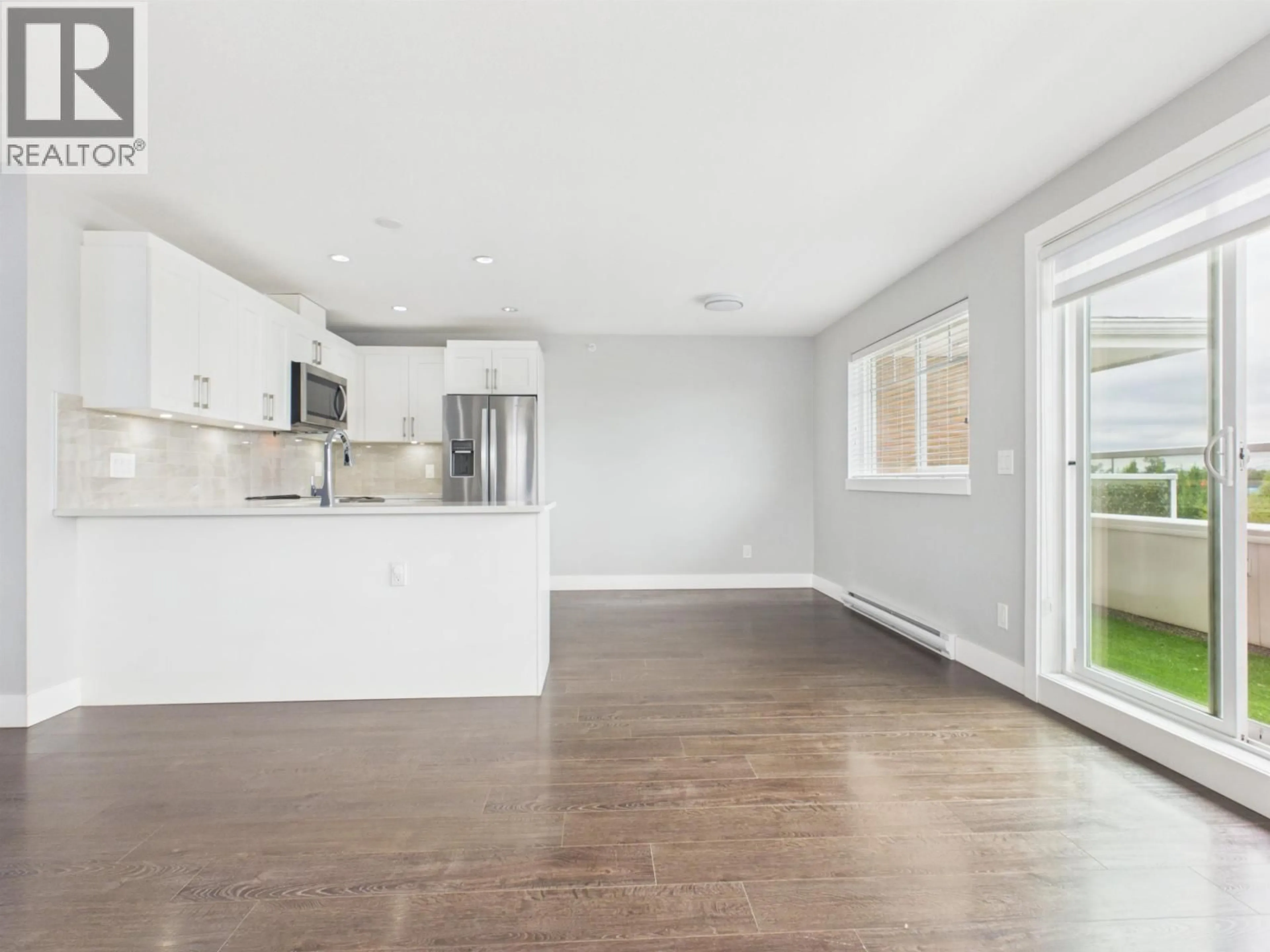 Open concept kitchen, wood/laminate floor for 402 - 1990 WESTMINSTER AVENUE, Port Coquitlam British Columbia V3B1E8
