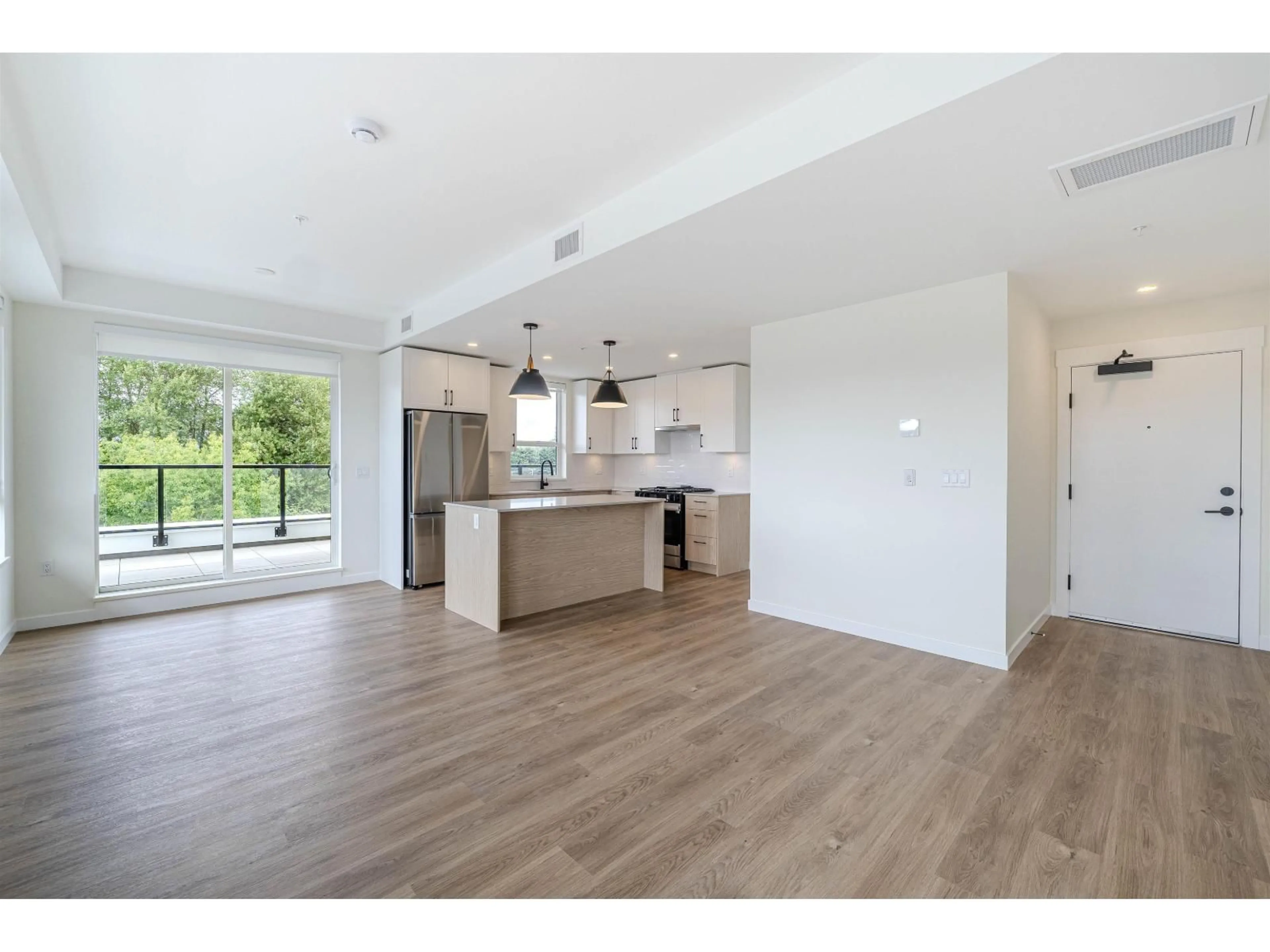 Open concept kitchen, wood/laminate floor for 606 - 27249 ALDERGROVE TOWN CENTRE DRIVE, Langley British Columbia V4W3N7