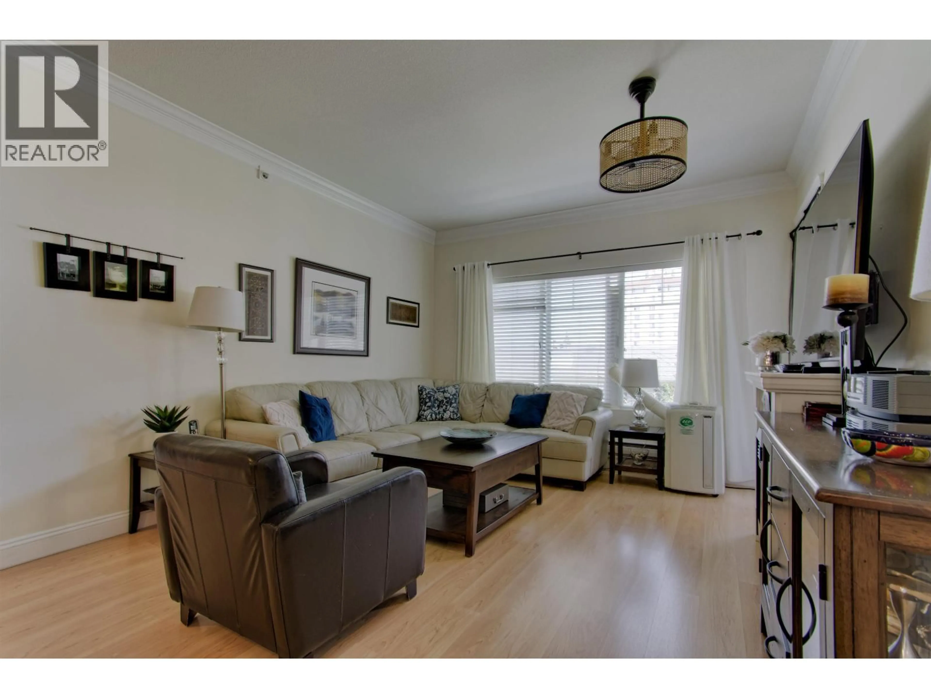 Living room with furniture, wood/laminate floor for 407 - 22150 DEWDNEY TRUNK ROAD, Maple Ridge British Columbia V2X3H6