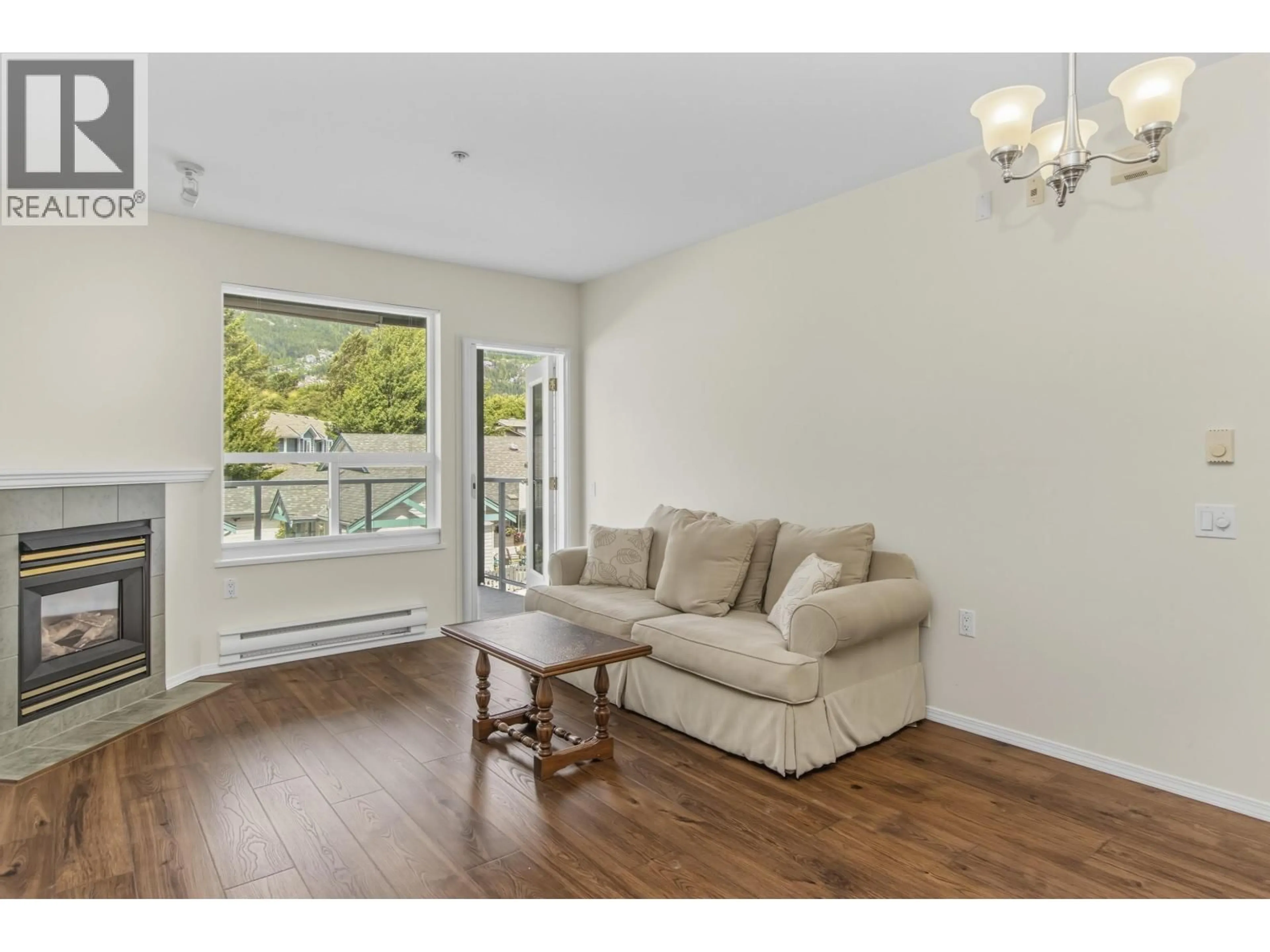 Living room with furniture, wood/laminate floor for 207 - 1203 PEMBERTON AVENUE, Squamish British Columbia V8B0J7