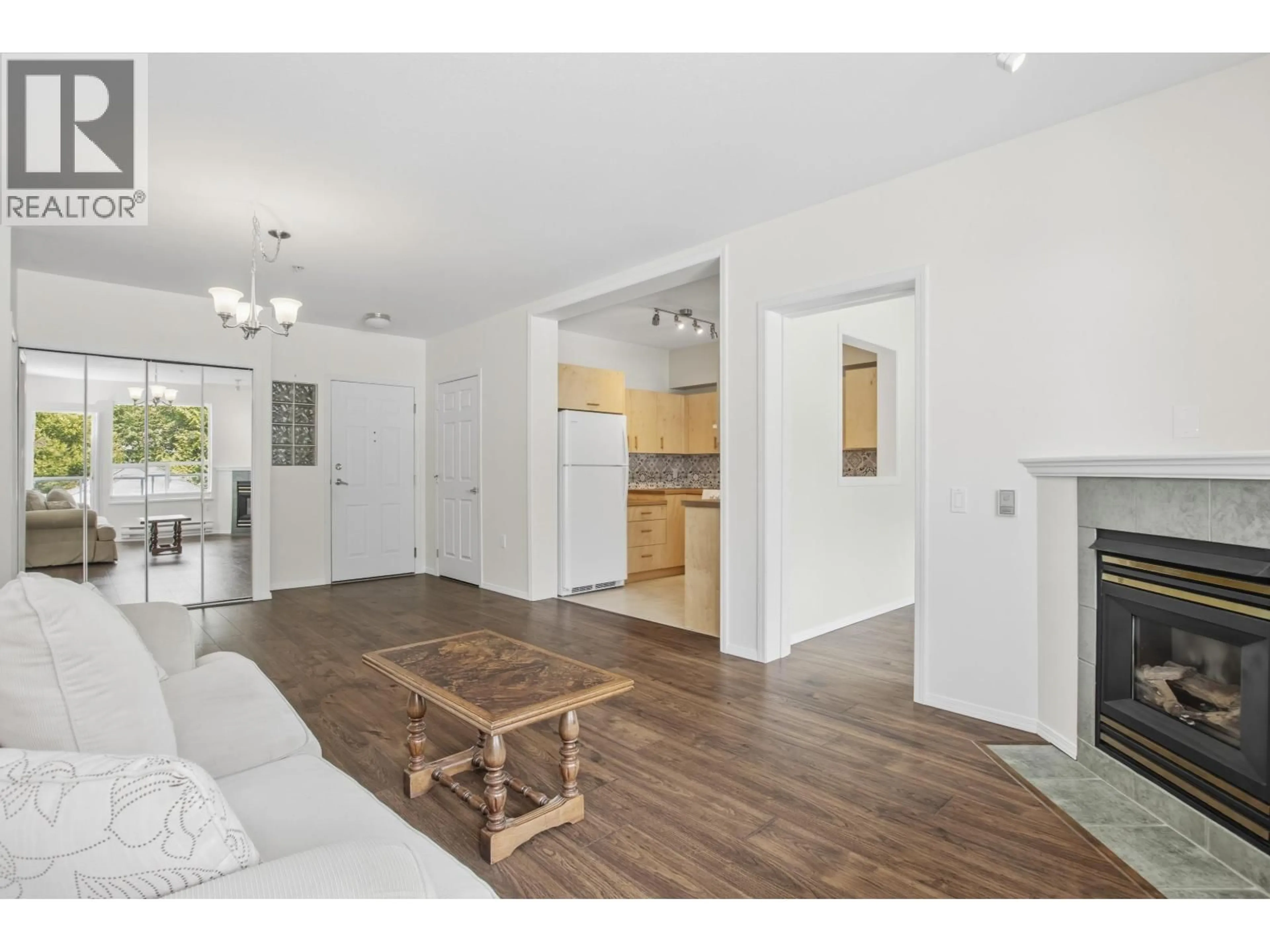 Living room with furniture, wood/laminate floor for 207 - 1203 PEMBERTON AVENUE, Squamish British Columbia V8B0J7