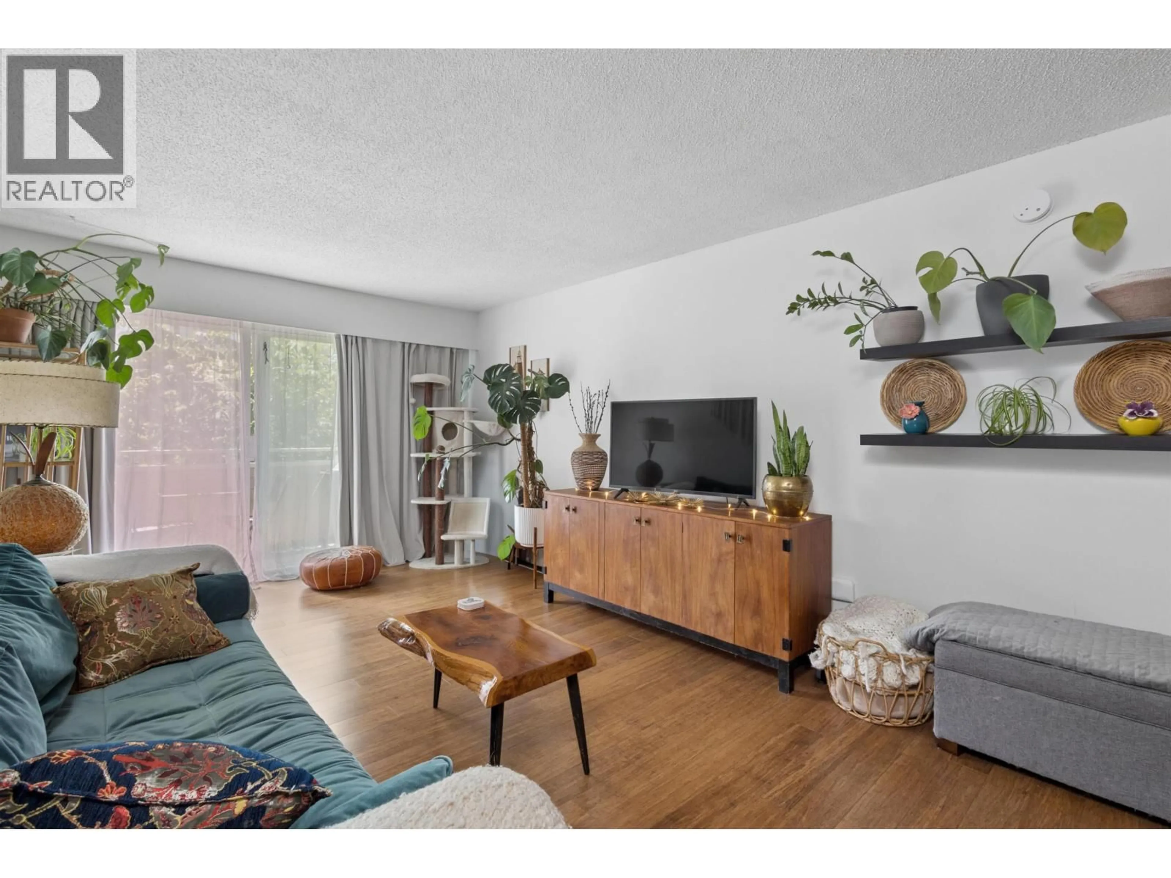 Living room with furniture, wood/laminate floor for 319 - 750 7TH AVENUE, Vancouver British Columbia V5T4H5