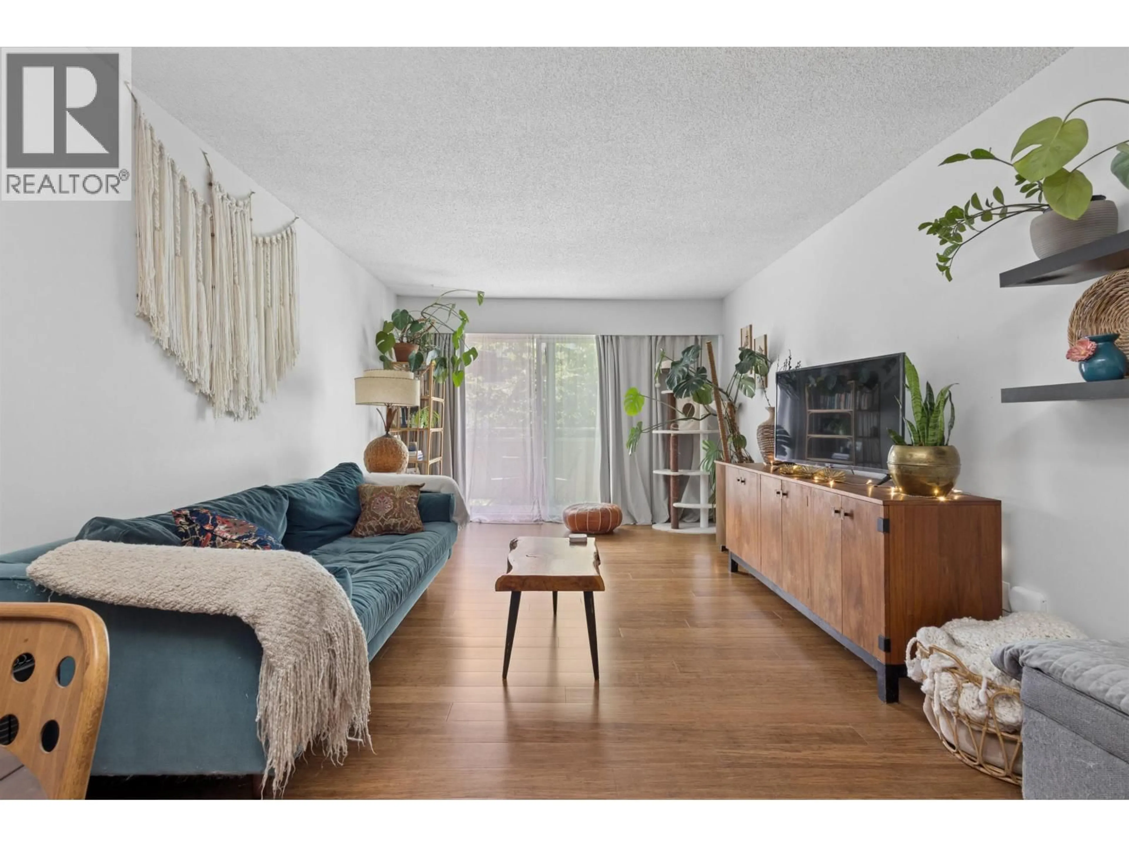Living room with furniture, wood/laminate floor for 319 - 750 7TH AVENUE, Vancouver British Columbia V5T4H5