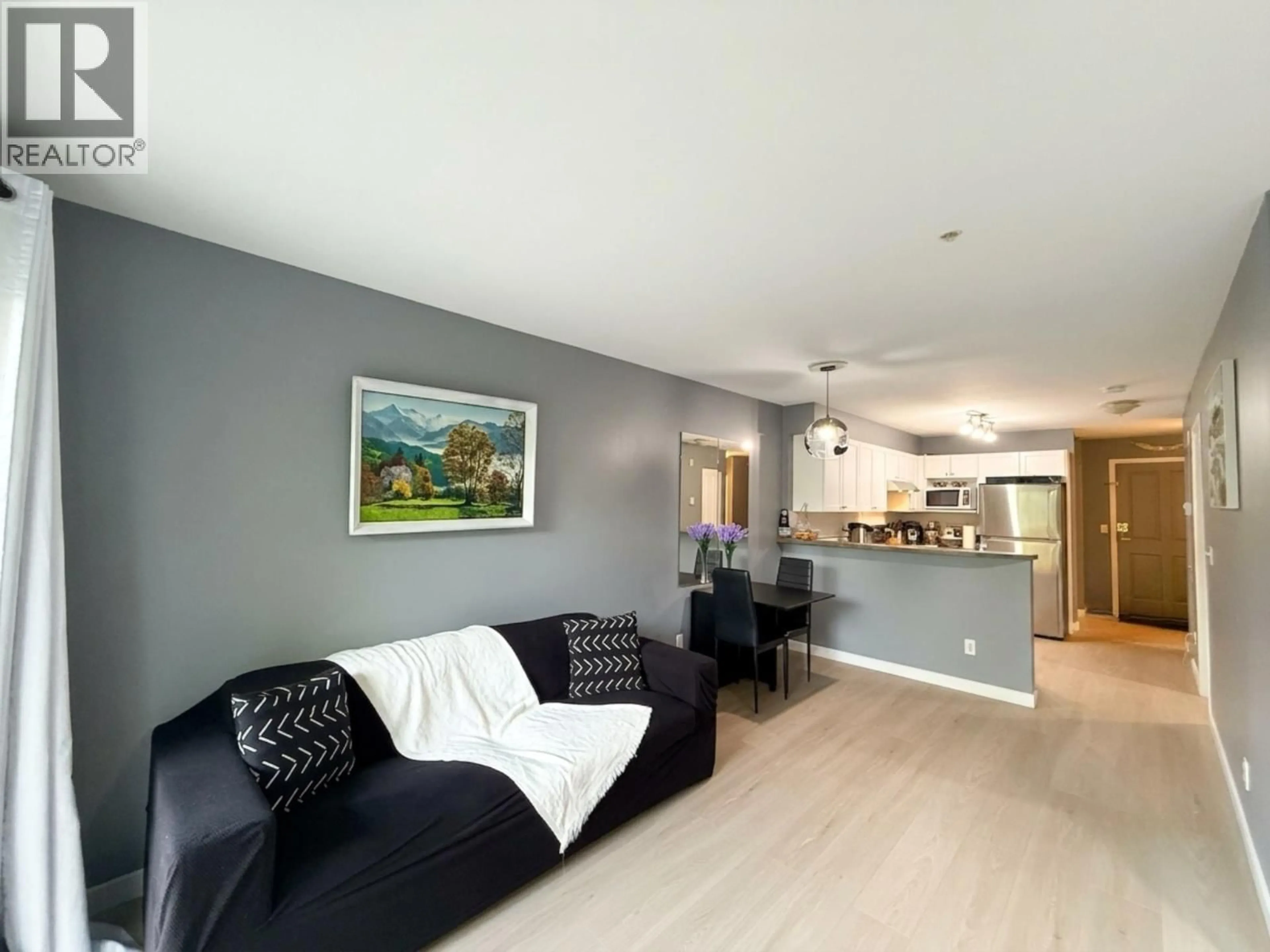 Living room with furniture, wood/laminate floor for 208 - 5355 BOUNDARY ROAD, Vancouver British Columbia V5R6G2