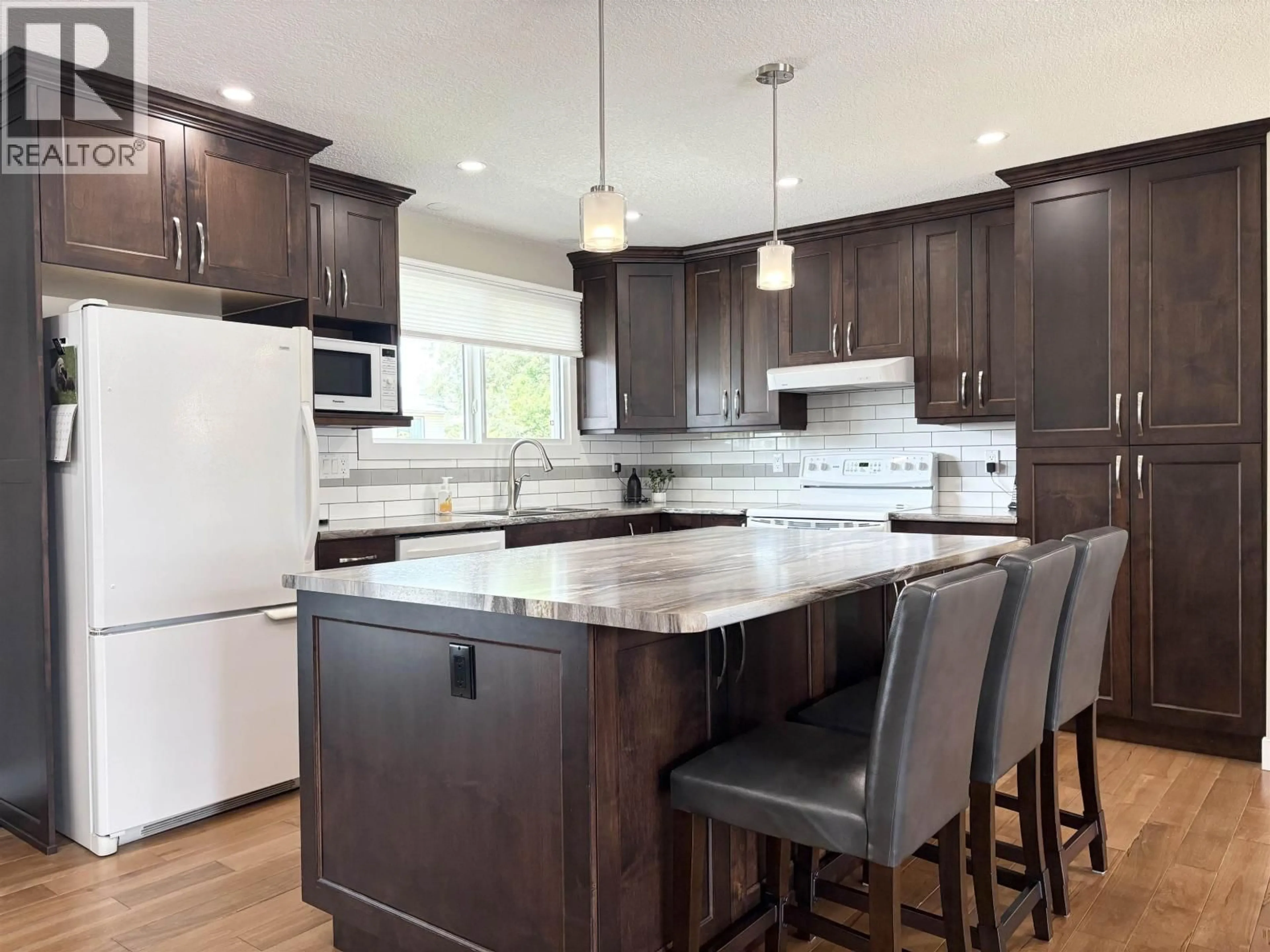 Open concept kitchen, wood/laminate floor for 2845 LONSDALE STREET, Prince George British Columbia V2L4W9