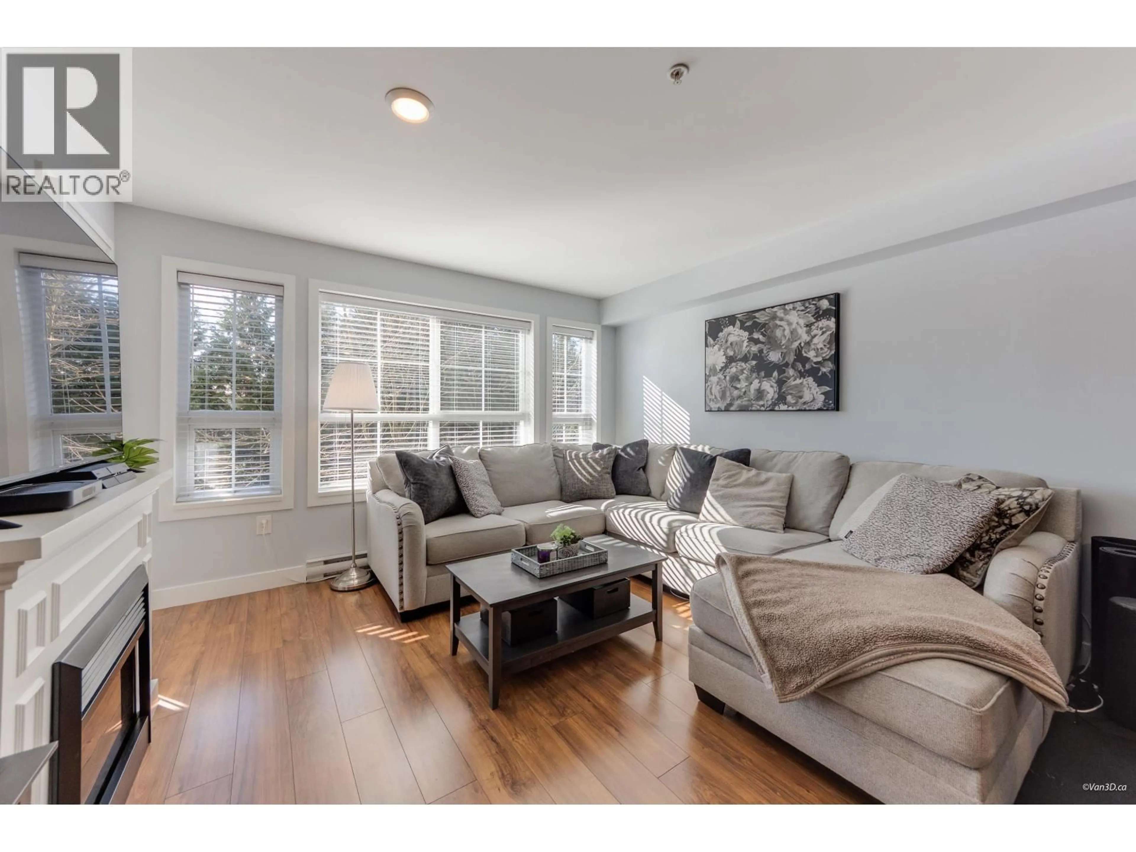 Living room with furniture, wood/laminate floor for 214 - 19677 MEADOW GARDENS WAY, Pitt Meadows British Columbia V3Y0A2
