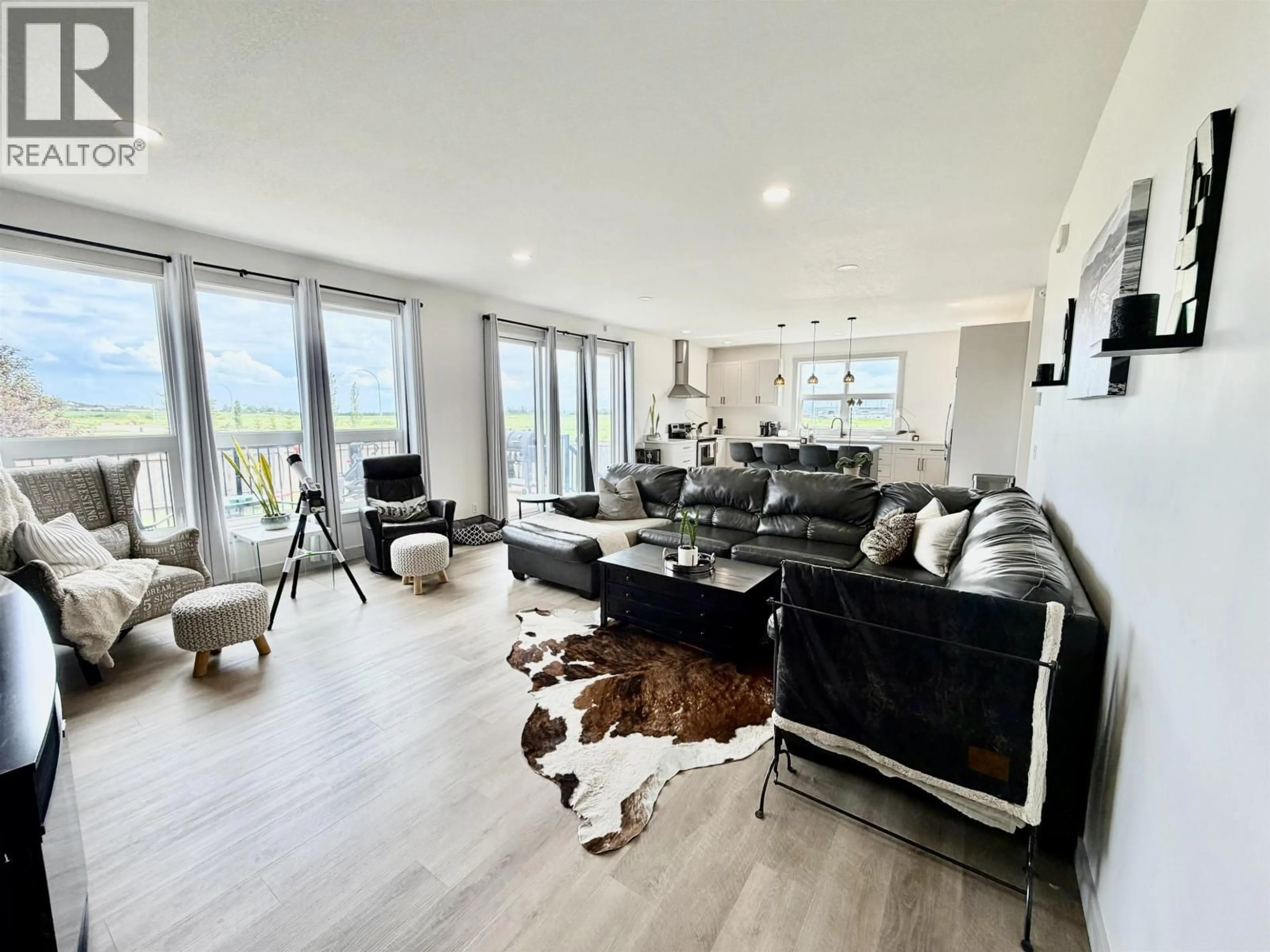 Living room with furniture, wood/laminate floor for 8107 81A STREET, Fort St. John British Columbia V1J0P6