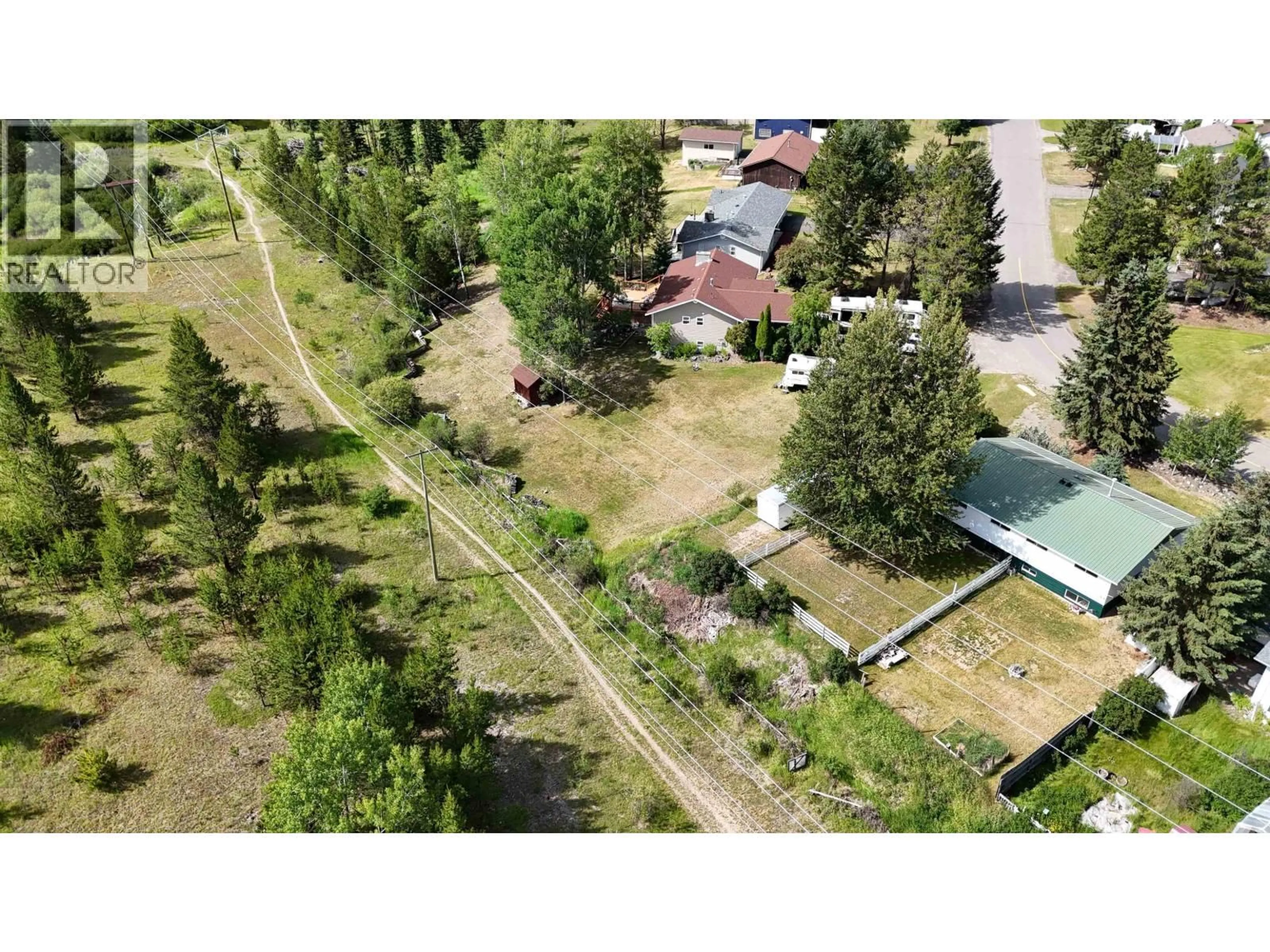 A pic from outside/outdoor area/front of a property/back of a property/a pic from drone, unknown for 461 EVERGREEN CRESCENT, 100 Mile House British Columbia V0K2E0