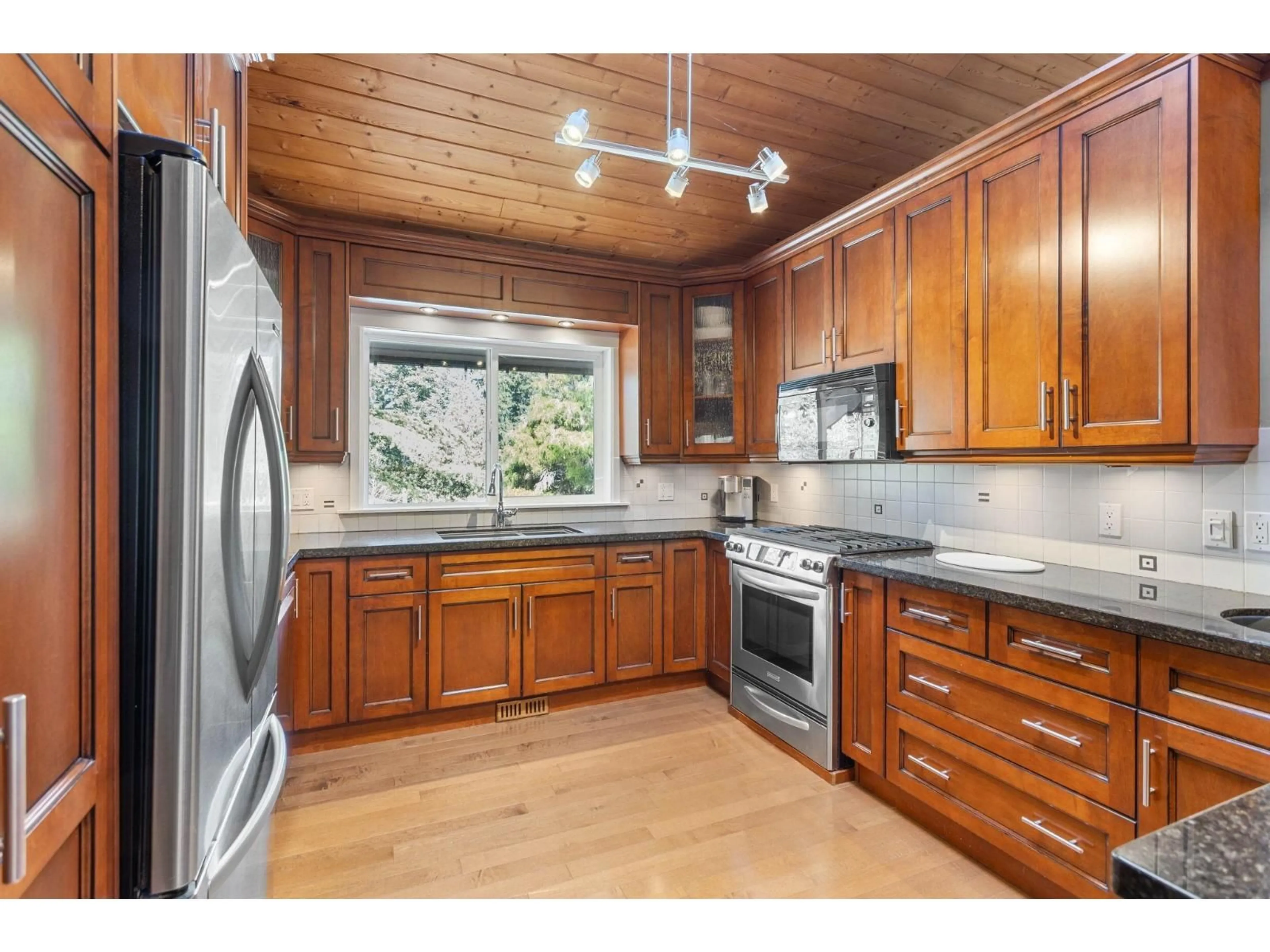 Open concept kitchen, wood/laminate floor for 23808 58A AVENUE, Langley British Columbia V2Z1A5