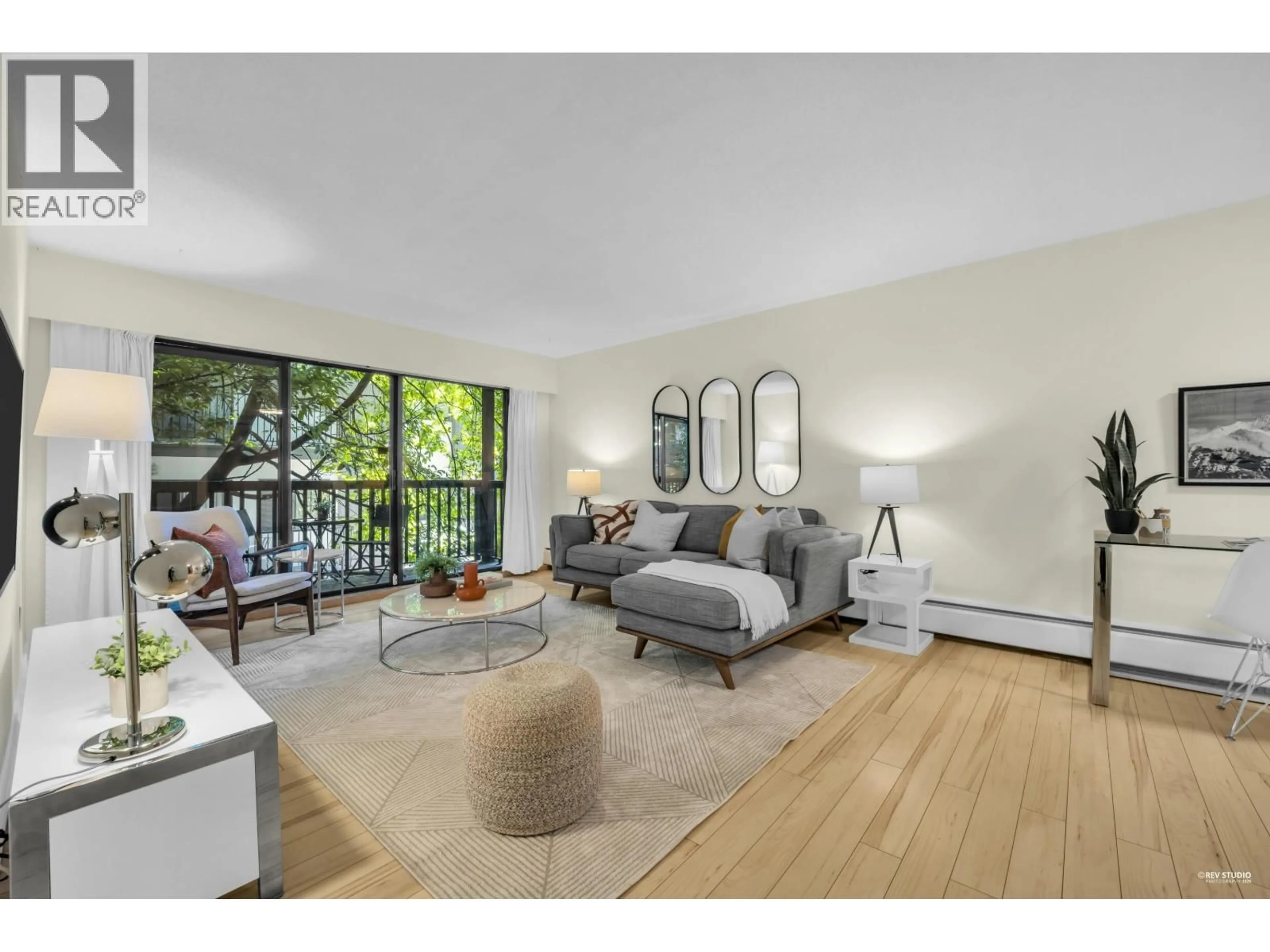 Living room with furniture, wood/laminate floor for 103 - 150 5TH STREET, North Vancouver British Columbia V7L1L5