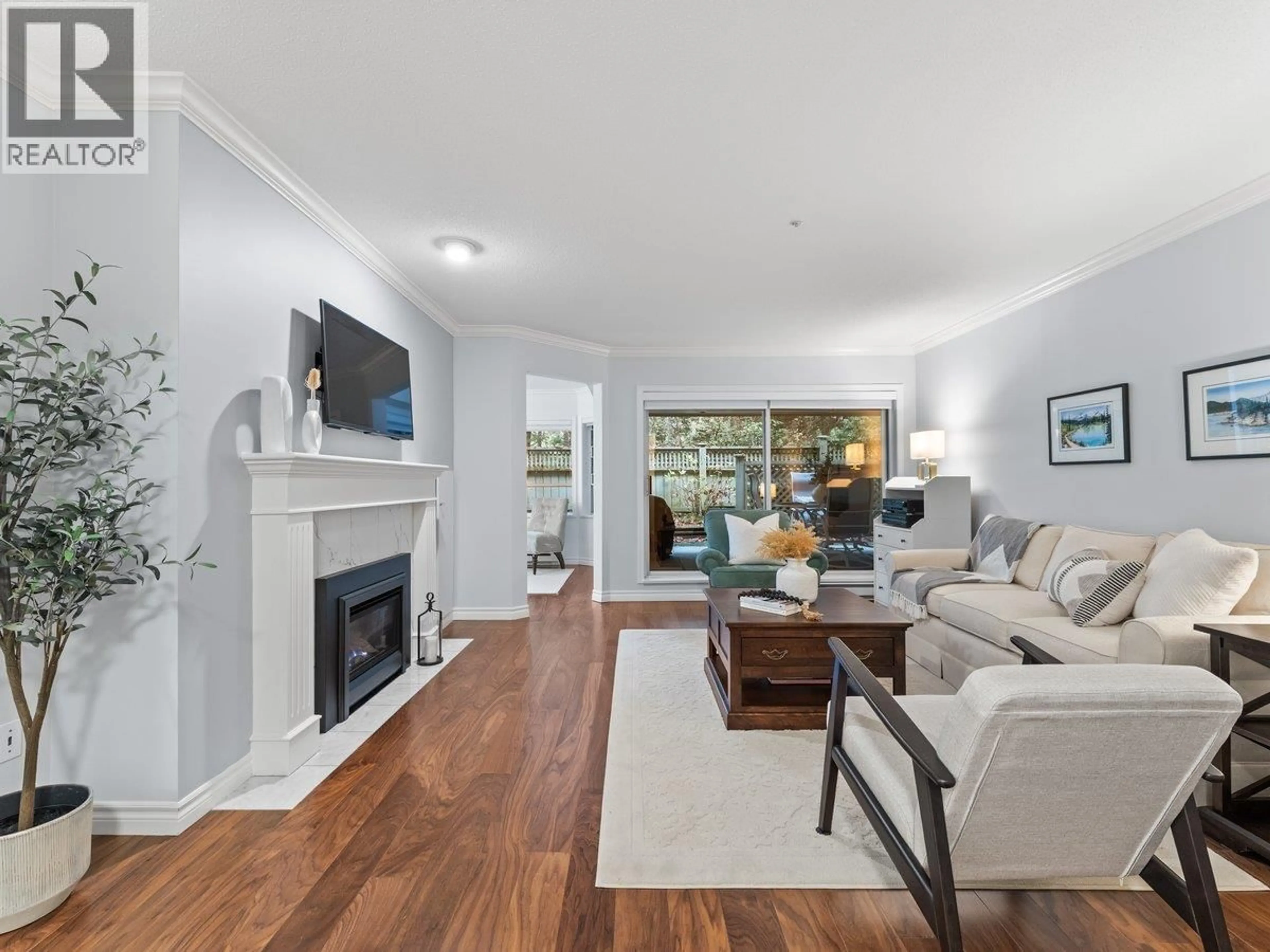 Living room with furniture, wood/laminate floor for 107 - 3690 BANFF COURT, North Vancouver British Columbia V7H2Y7