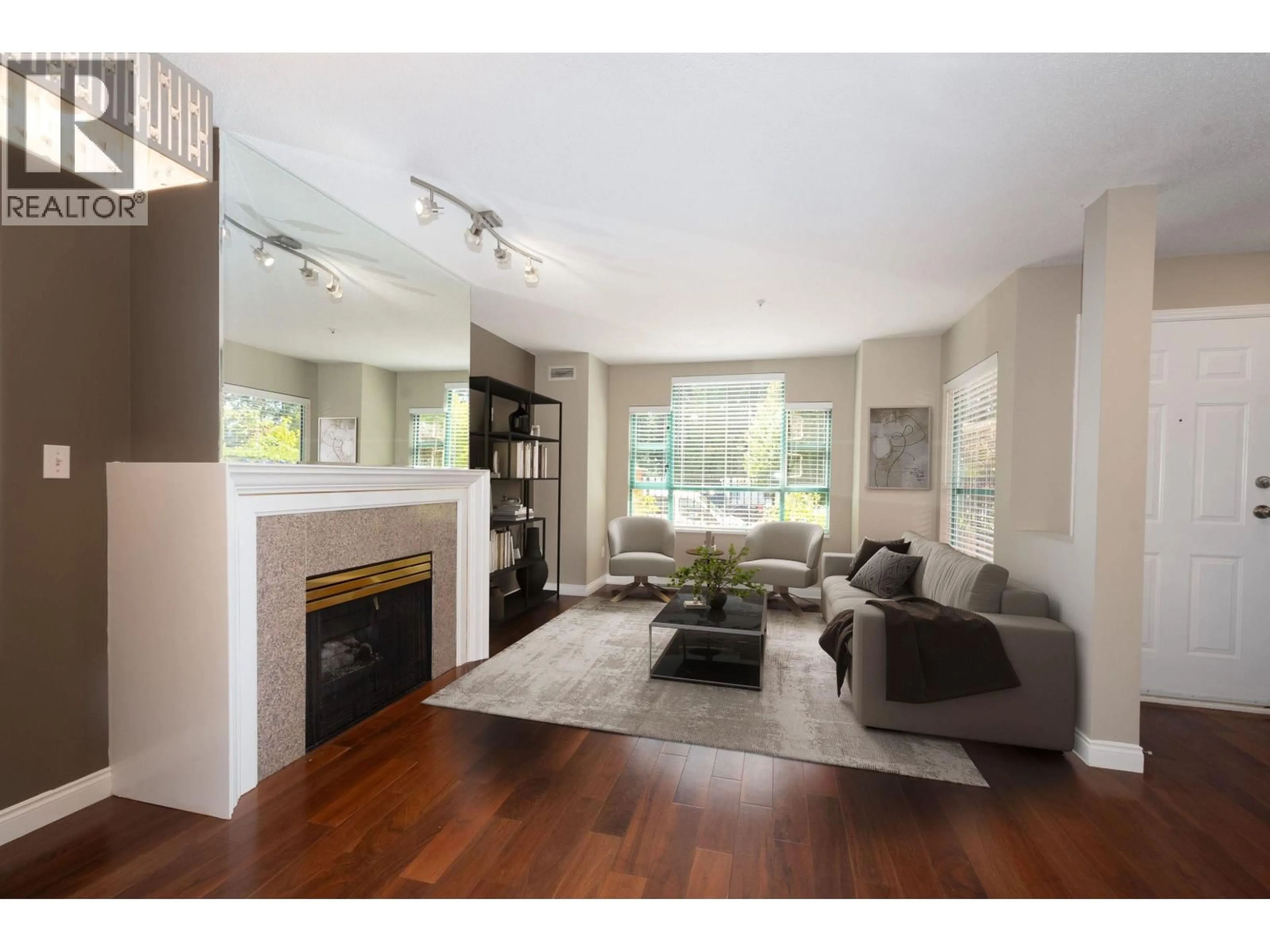 Living room with furniture, wood/laminate floor for 108E - 3081 GLEN DRIVE, Coquitlam British Columbia V3B2P8