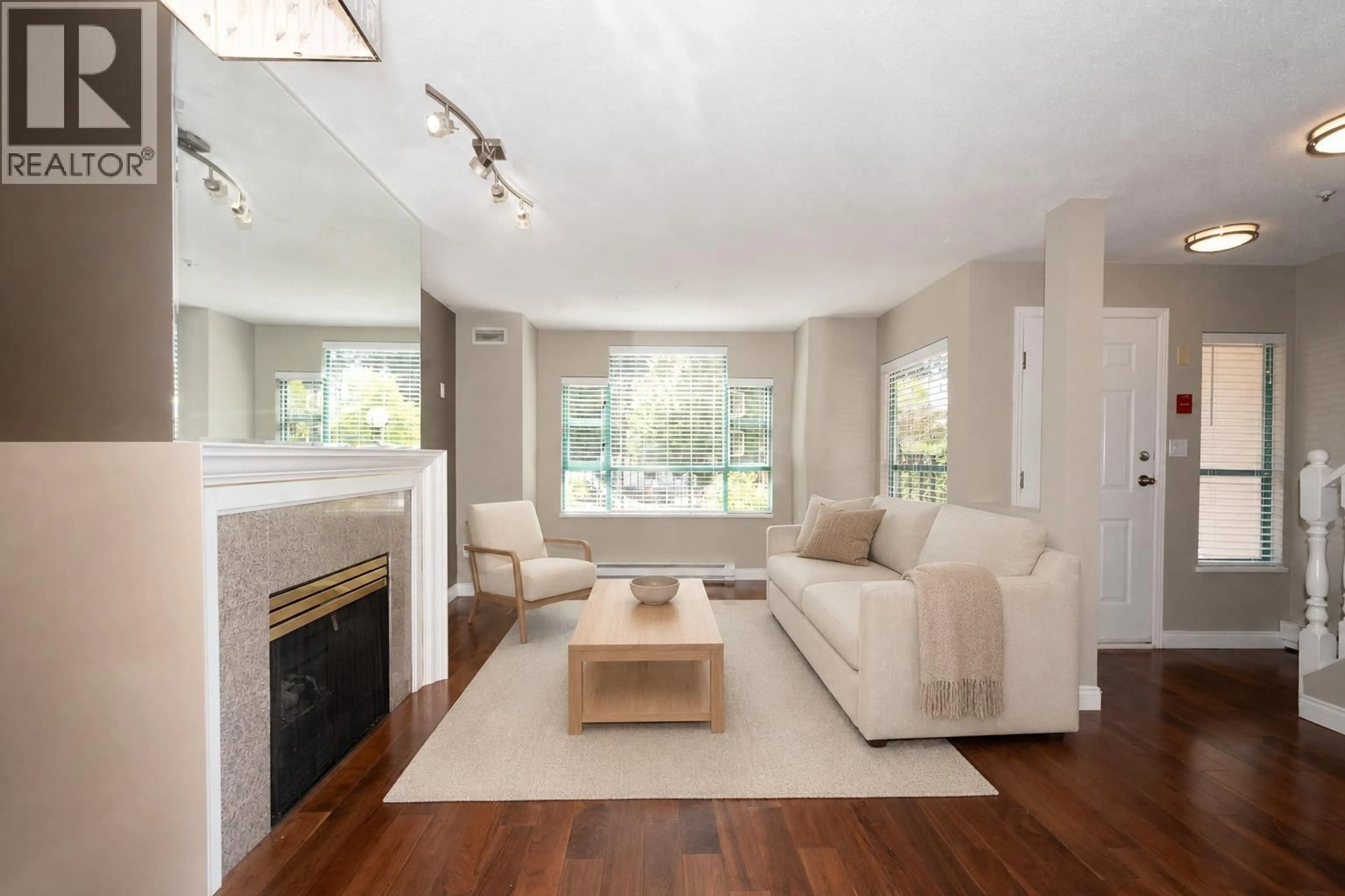 Living room with furniture, wood/laminate floor for 108E - 3081 GLEN DRIVE, Coquitlam British Columbia V3B2P8