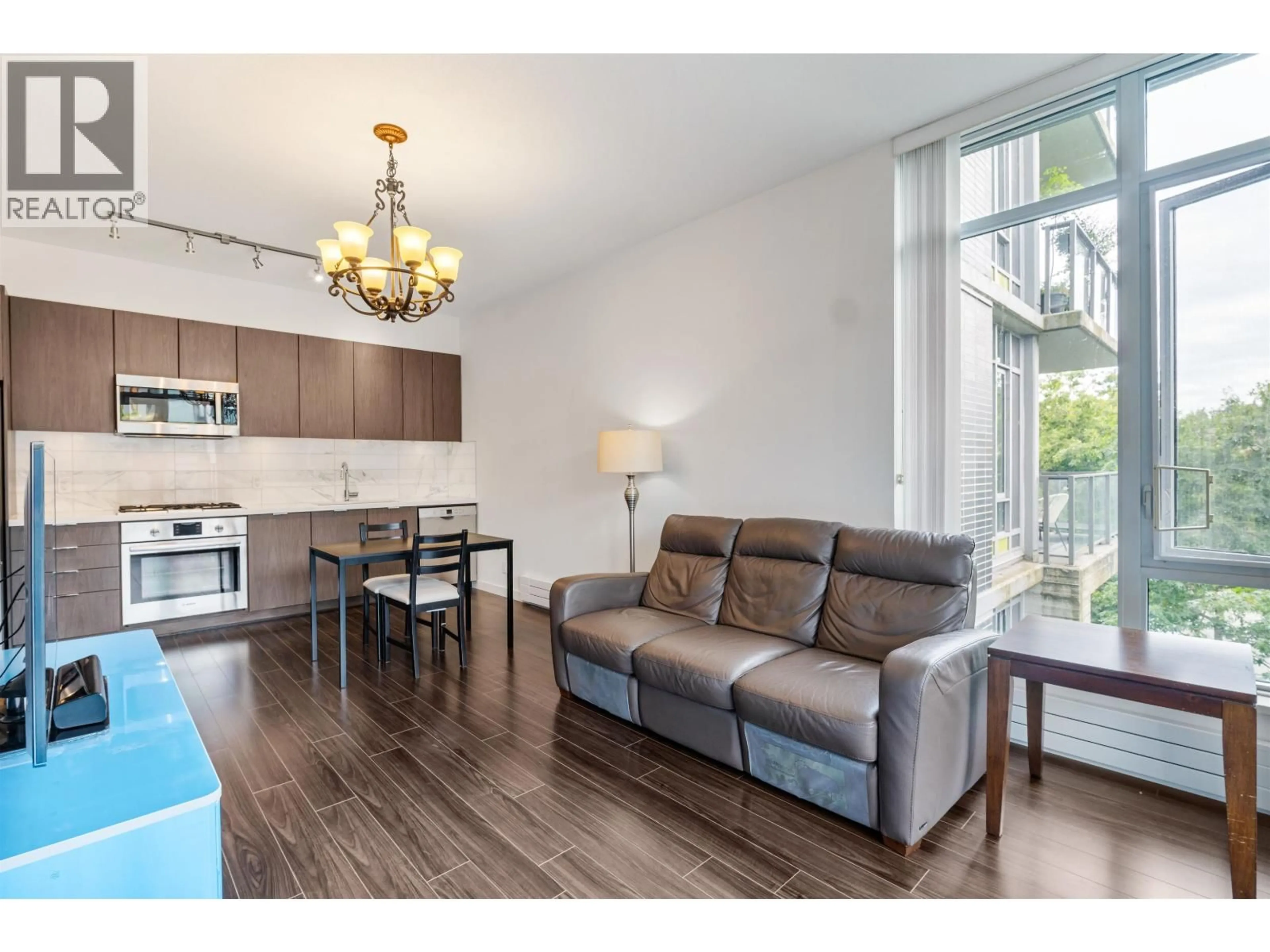 Living room with furniture, wood/laminate floor for 301 - 3168 RIVERWALK AVENUE, Vancouver British Columbia V5S0B8