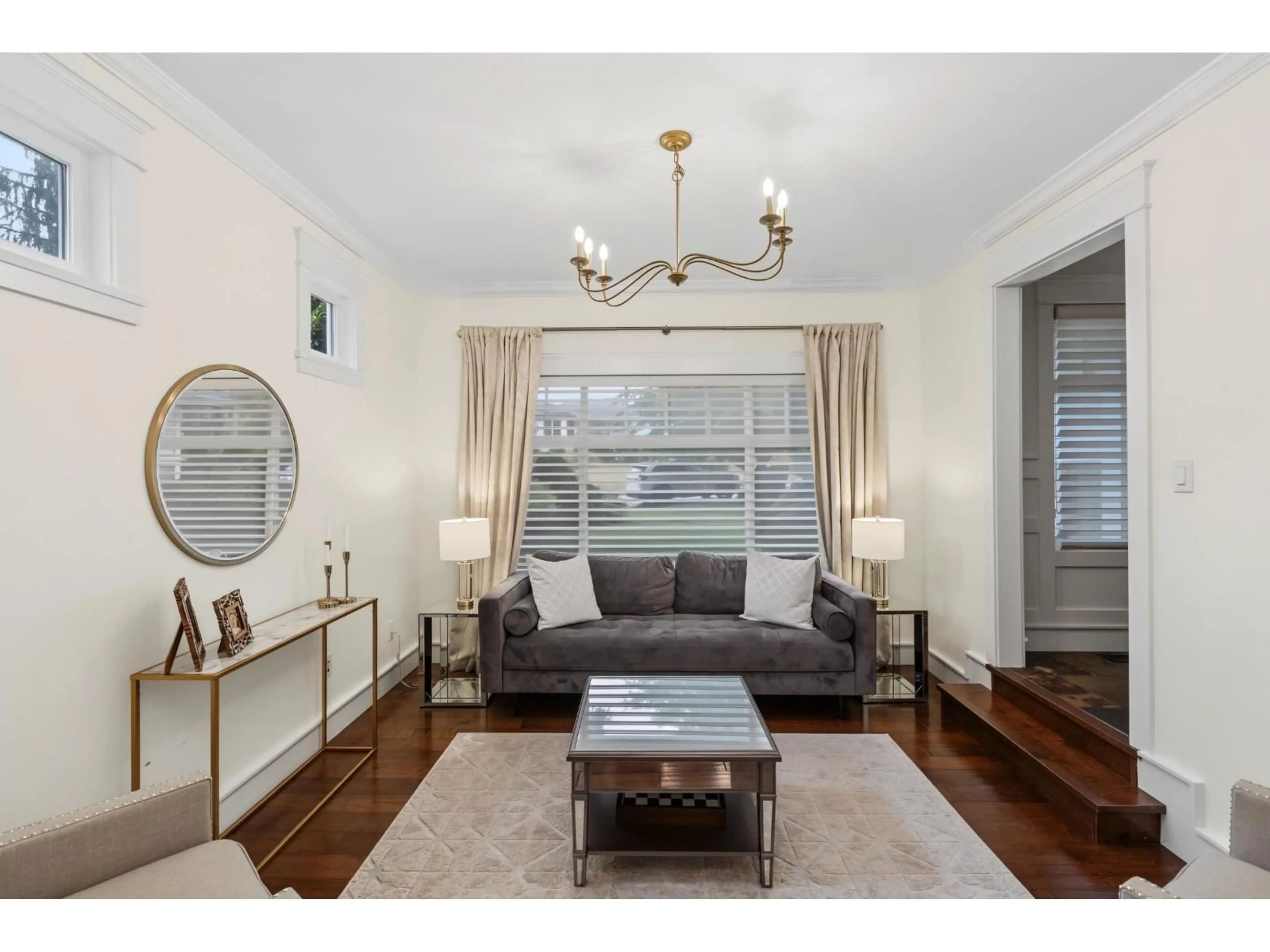 Living room with furniture, wood/laminate floor for 7785 143 STREET, Surrey British Columbia V3W0L2