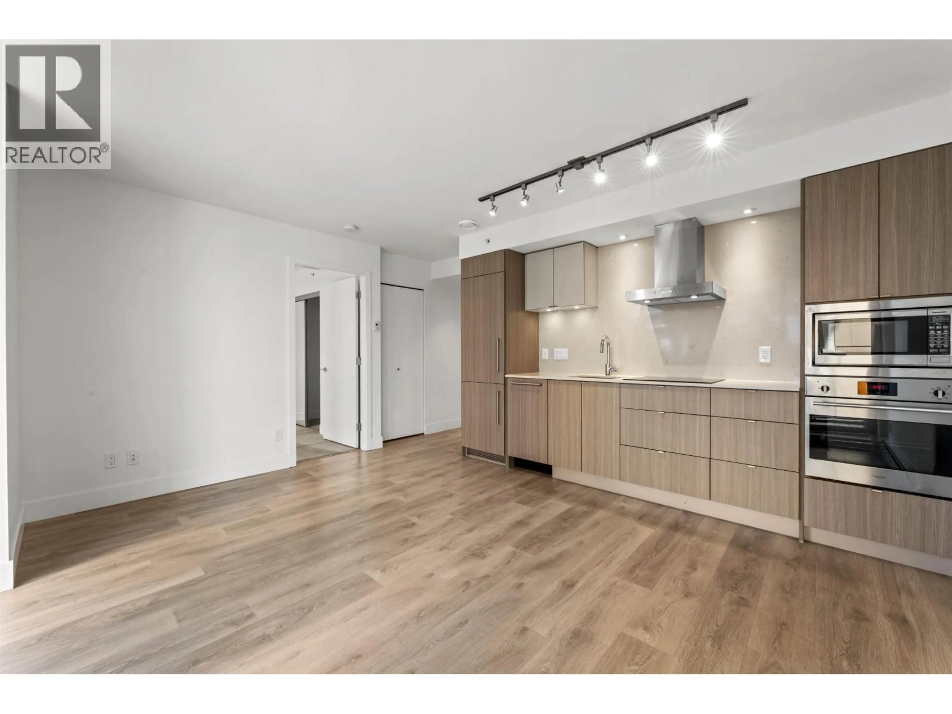 Open concept kitchen, wood/laminate floor for 210 - 1788 COLUMBIA STREET, Vancouver British Columbia V5Y0L7