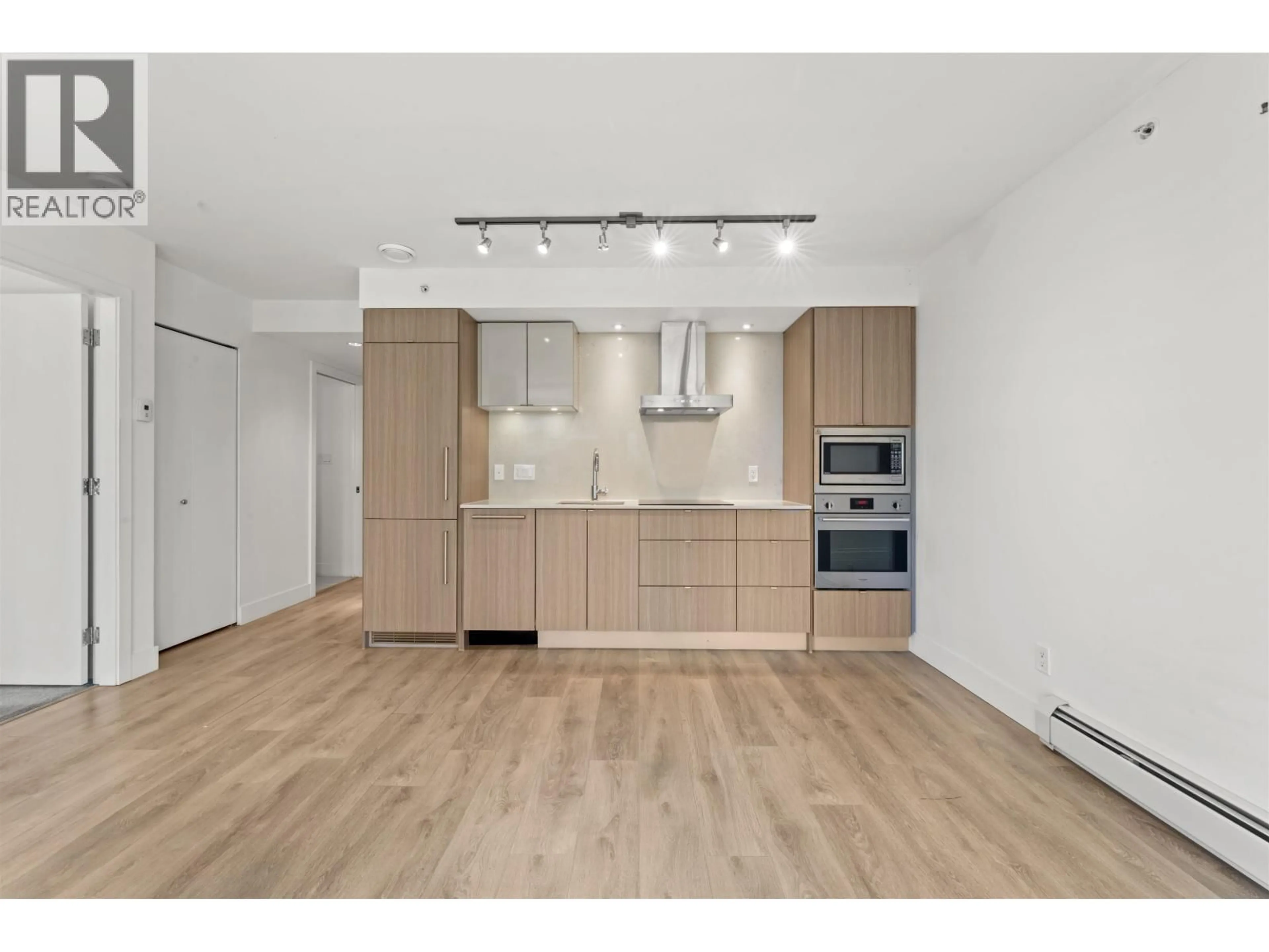 Open concept kitchen, wood/laminate floor for 210 - 1788 COLUMBIA STREET, Vancouver British Columbia V5Y0L7