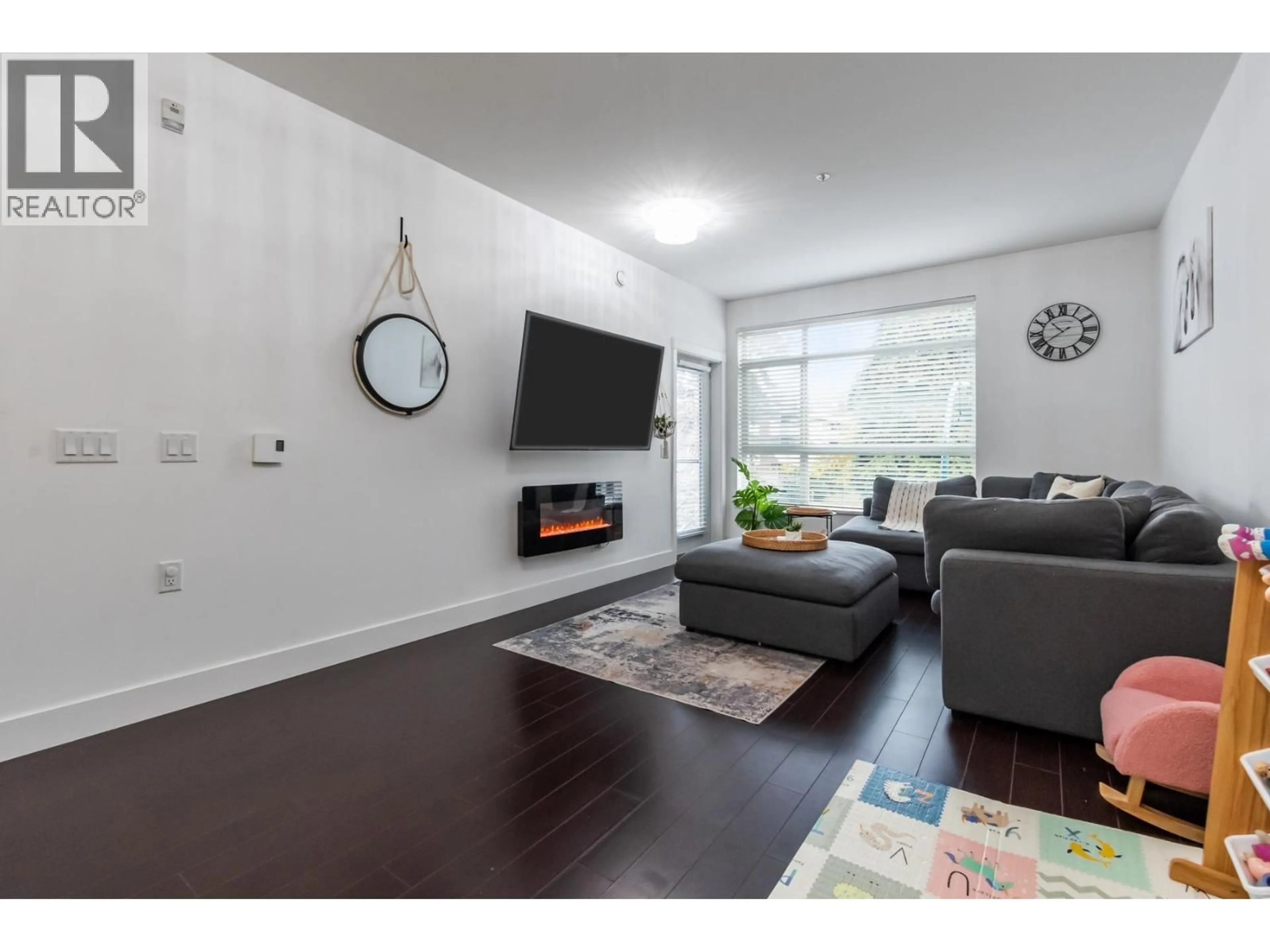 Living room with furniture, wood/laminate floor for 205 - 2436 KELLY AVENUE, Port Coquitlam British Columbia V3C1Y4