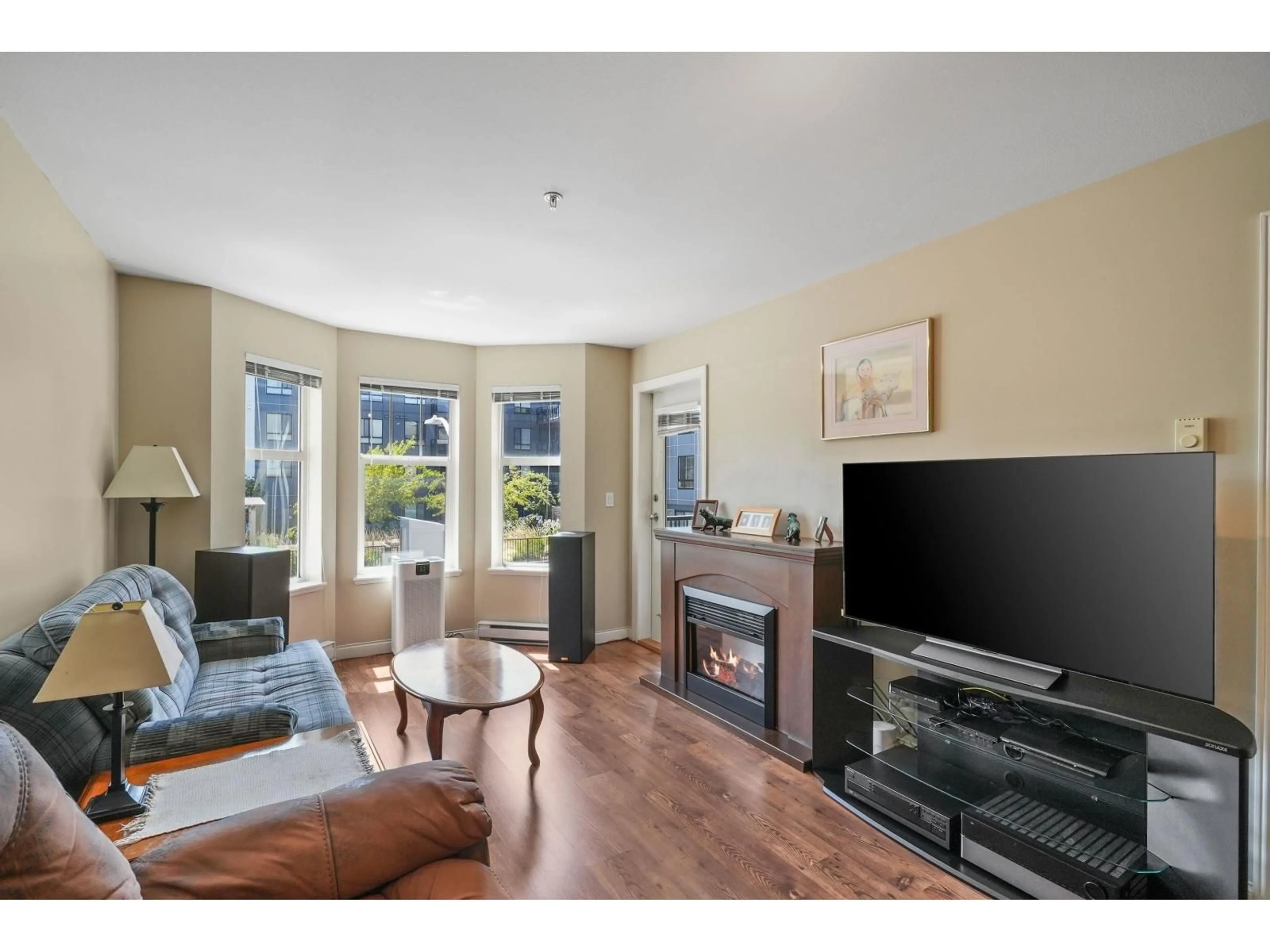 Living room with furniture, wood/laminate floor for 212 - 5438 198 STREET, Langley British Columbia V3A1G2