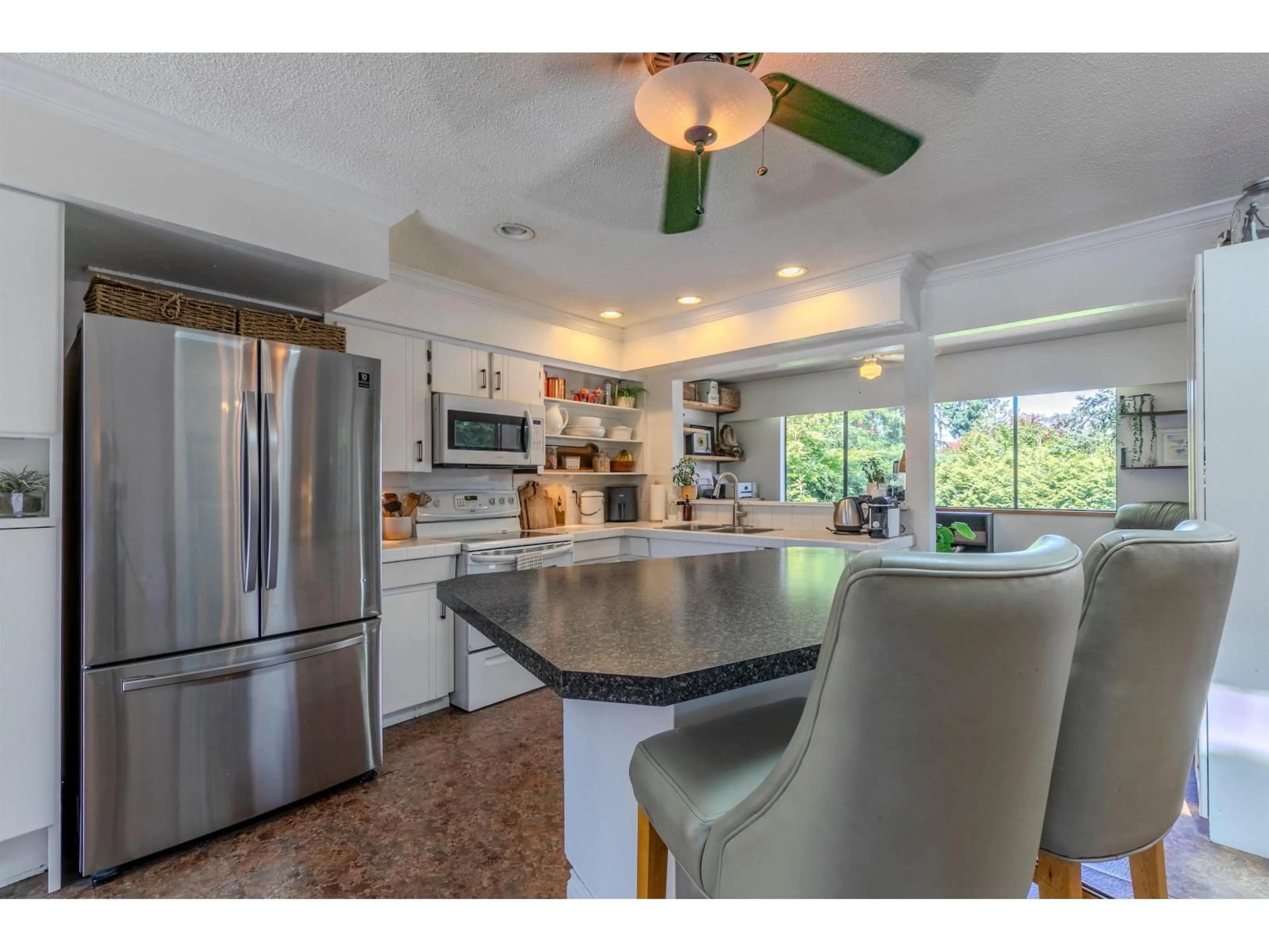 Open concept kitchen, ceramic/tile floor for 11307 83 AVENUE, Delta British Columbia V4C7B9