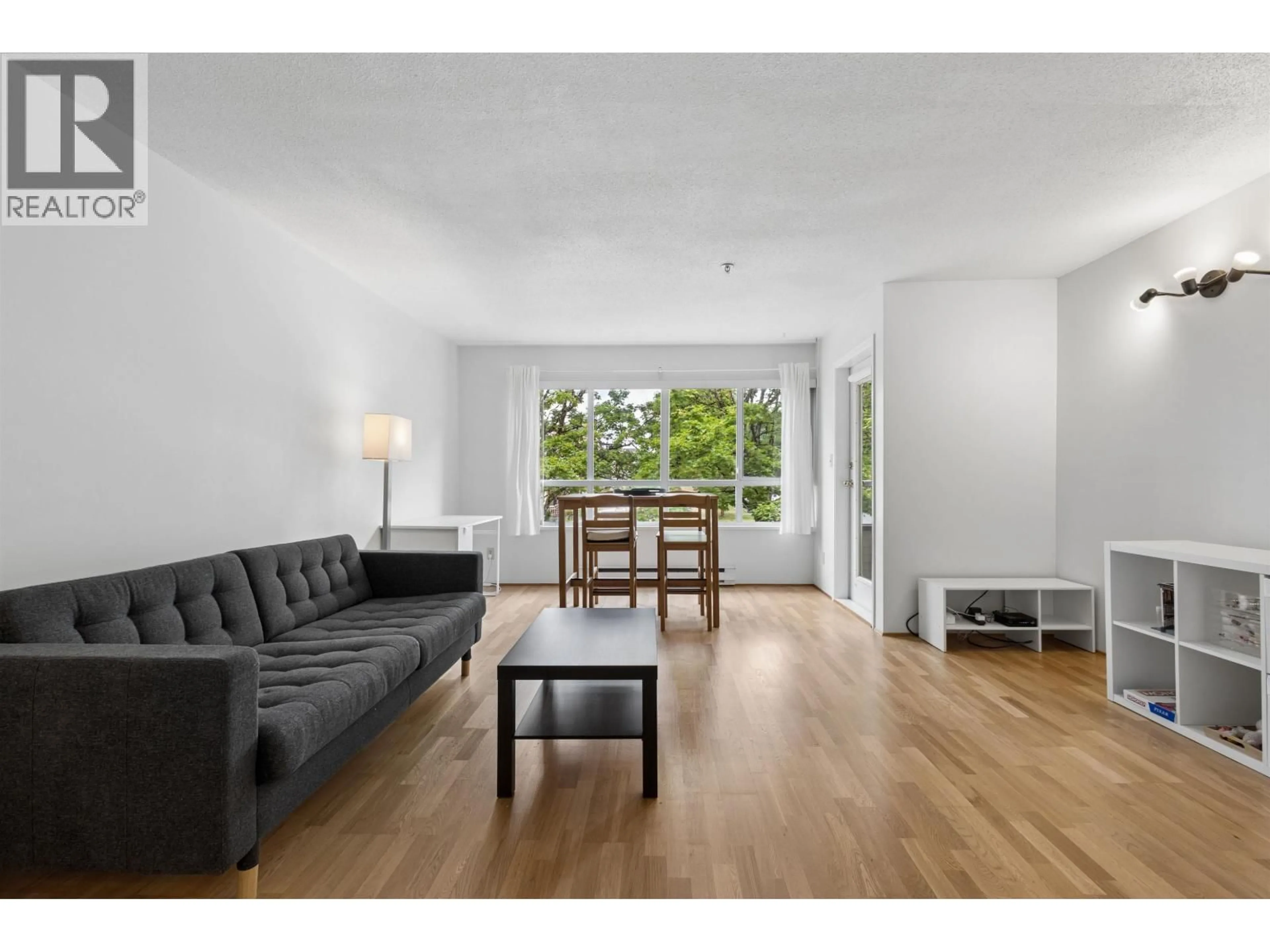Living room with furniture, wood/laminate floor for 204 - 4990 MCGEER STREET, Vancouver British Columbia V5R6C1