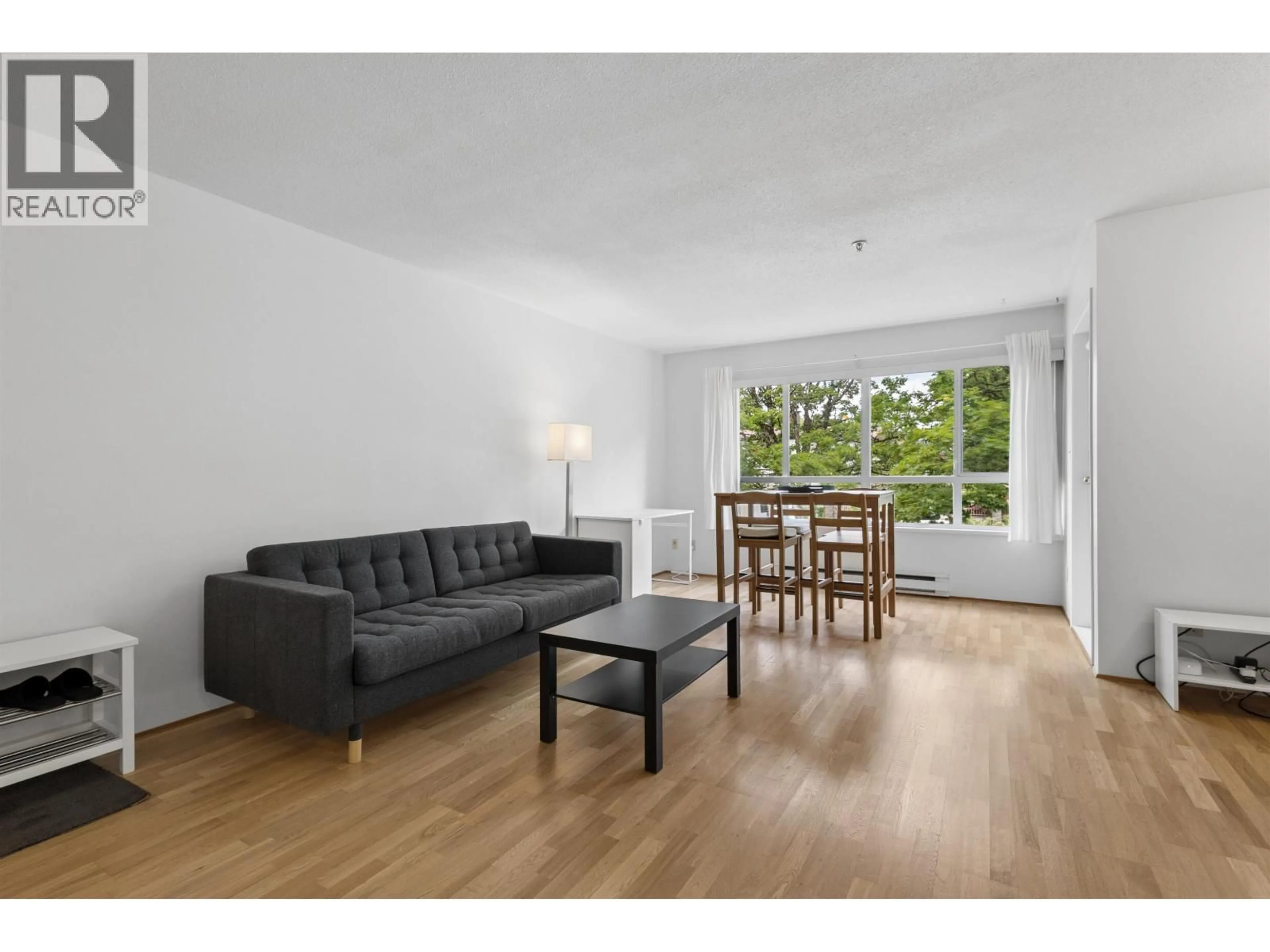 Living room with furniture, wood/laminate floor for 204 - 4990 MCGEER STREET, Vancouver British Columbia V5R6C1