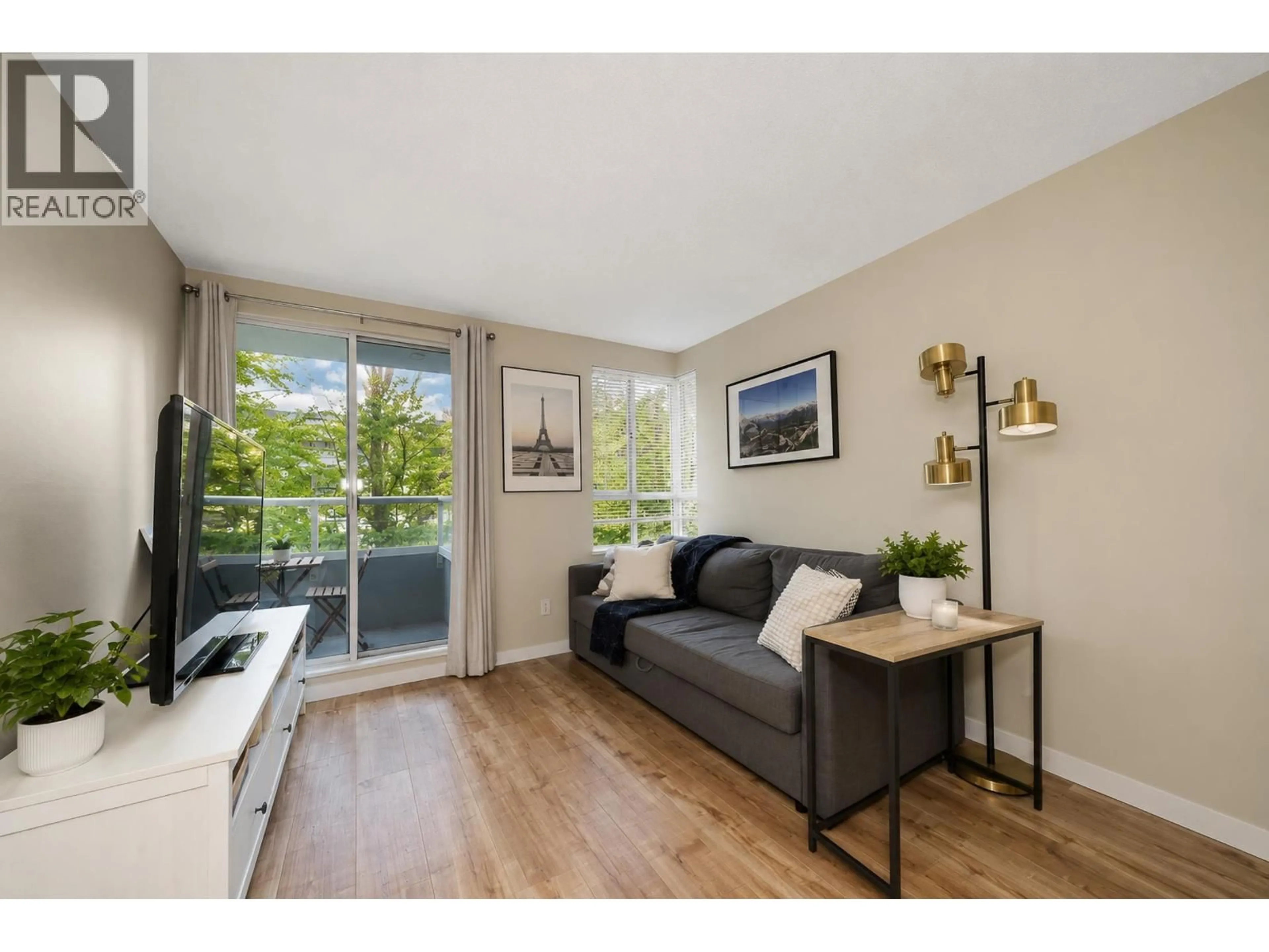 Living room with furniture, wood/laminate floor for 305 - 3489 ASCOT PLACE, Vancouver British Columbia V5R6B6