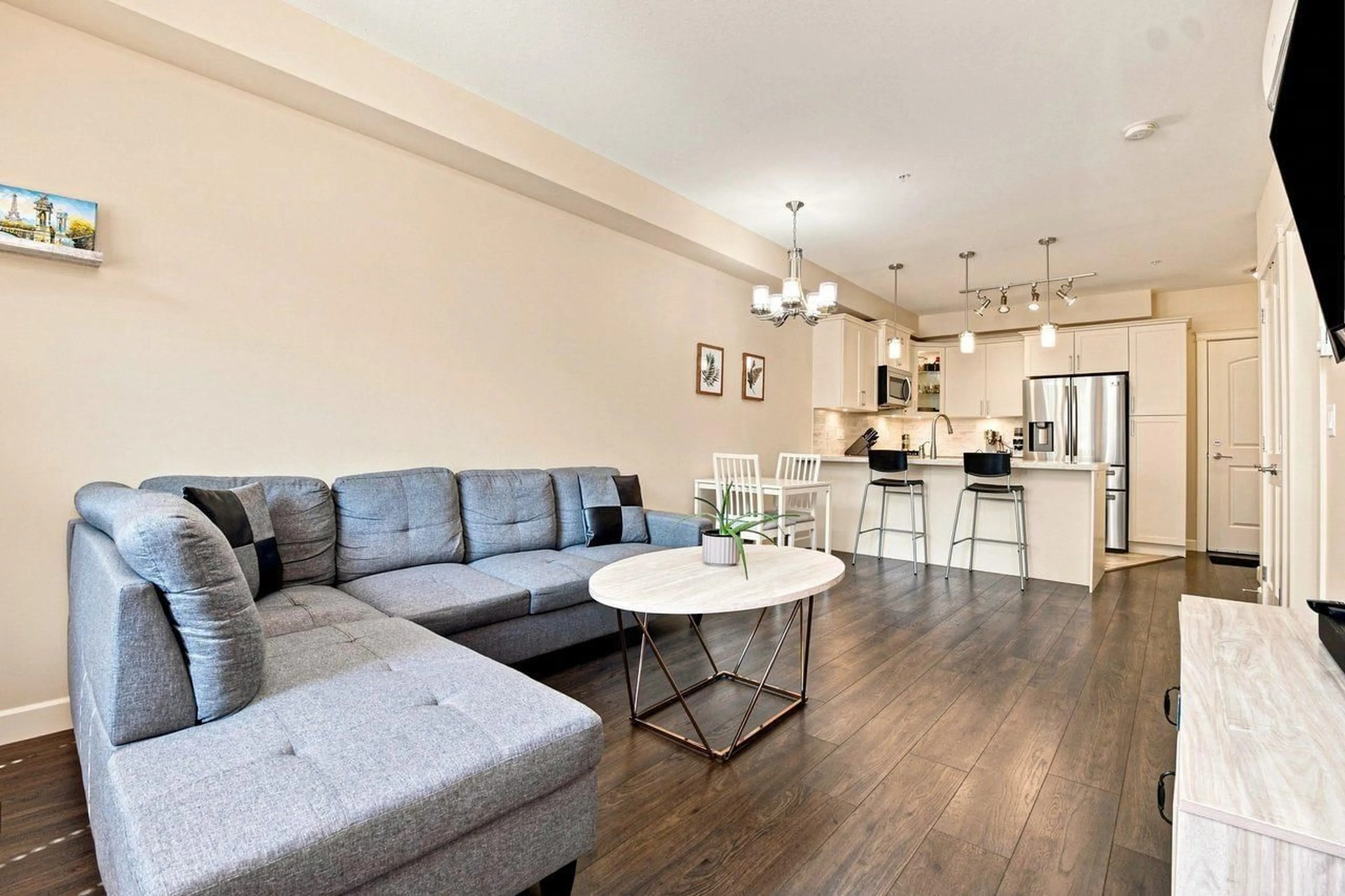 Living room with furniture, wood/laminate floor for 303 - 3585 146A STREET, Surrey British Columbia V4P0G9
