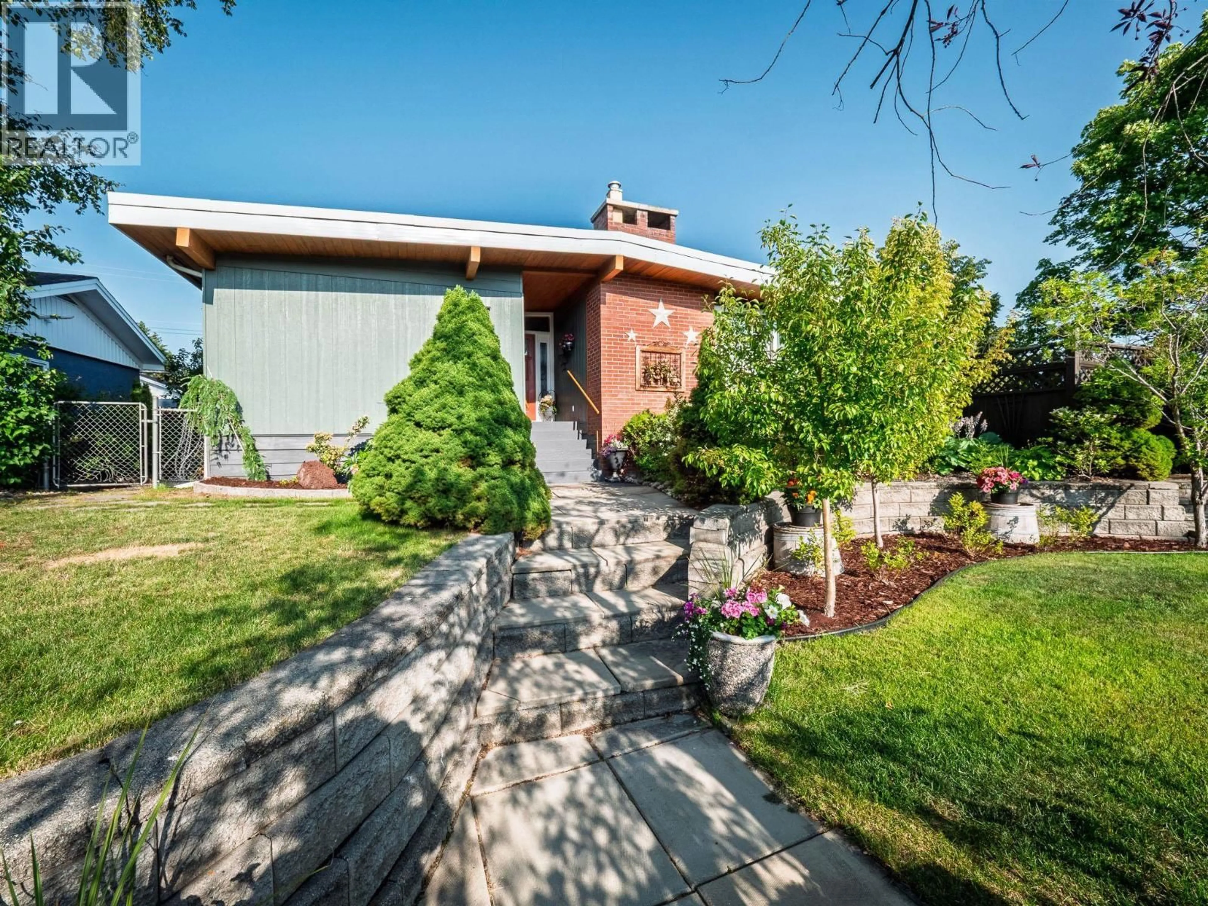 Home with brick exterior material, street for 1094 IRWIN STREET, Prince George British Columbia V2M2Y2