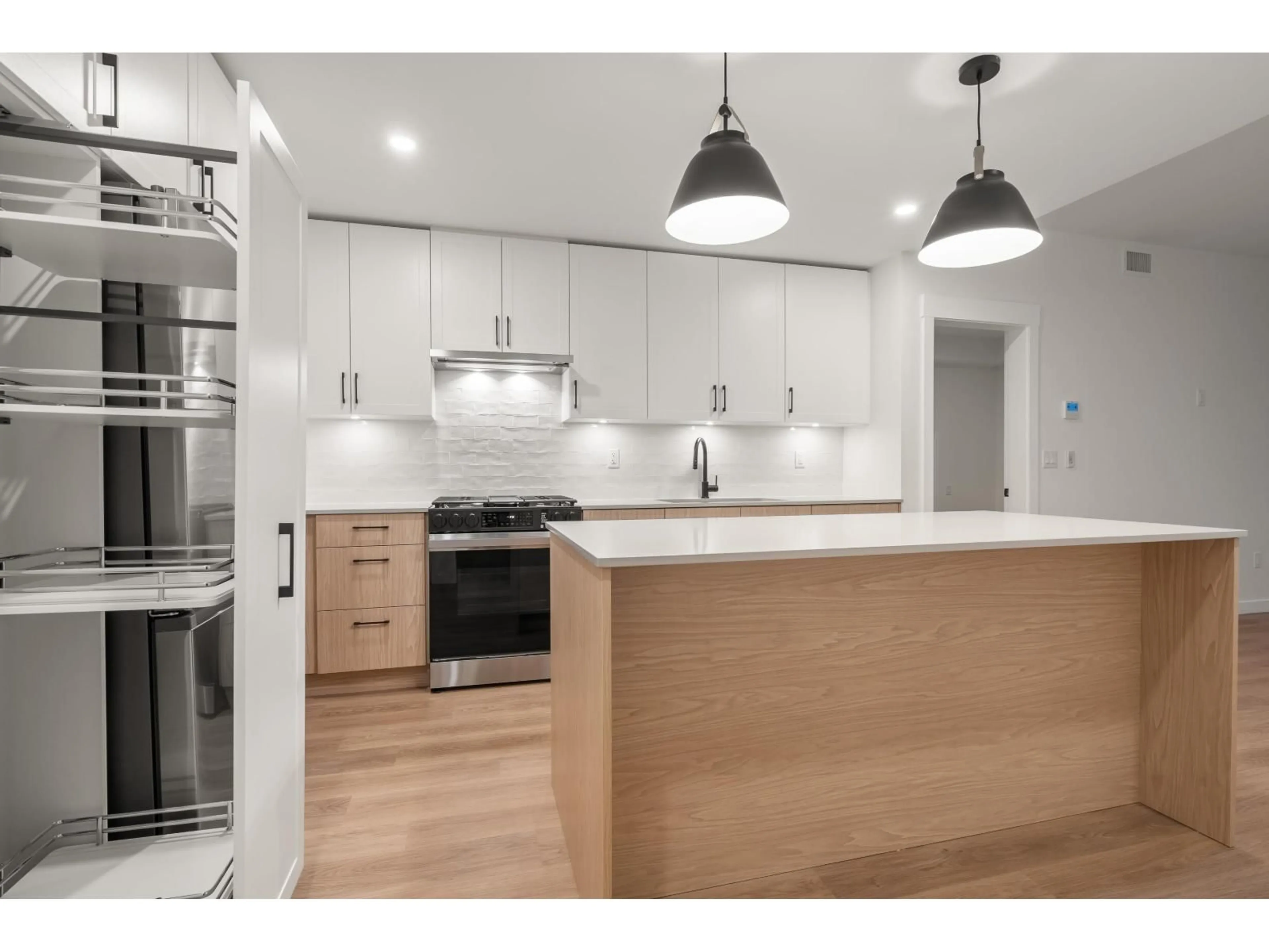 Open concept kitchen, wood/laminate floor for 203 - 27218 ALDERGROVE TOWN CENTRE DRIVE, Langley British Columbia V4W3N7